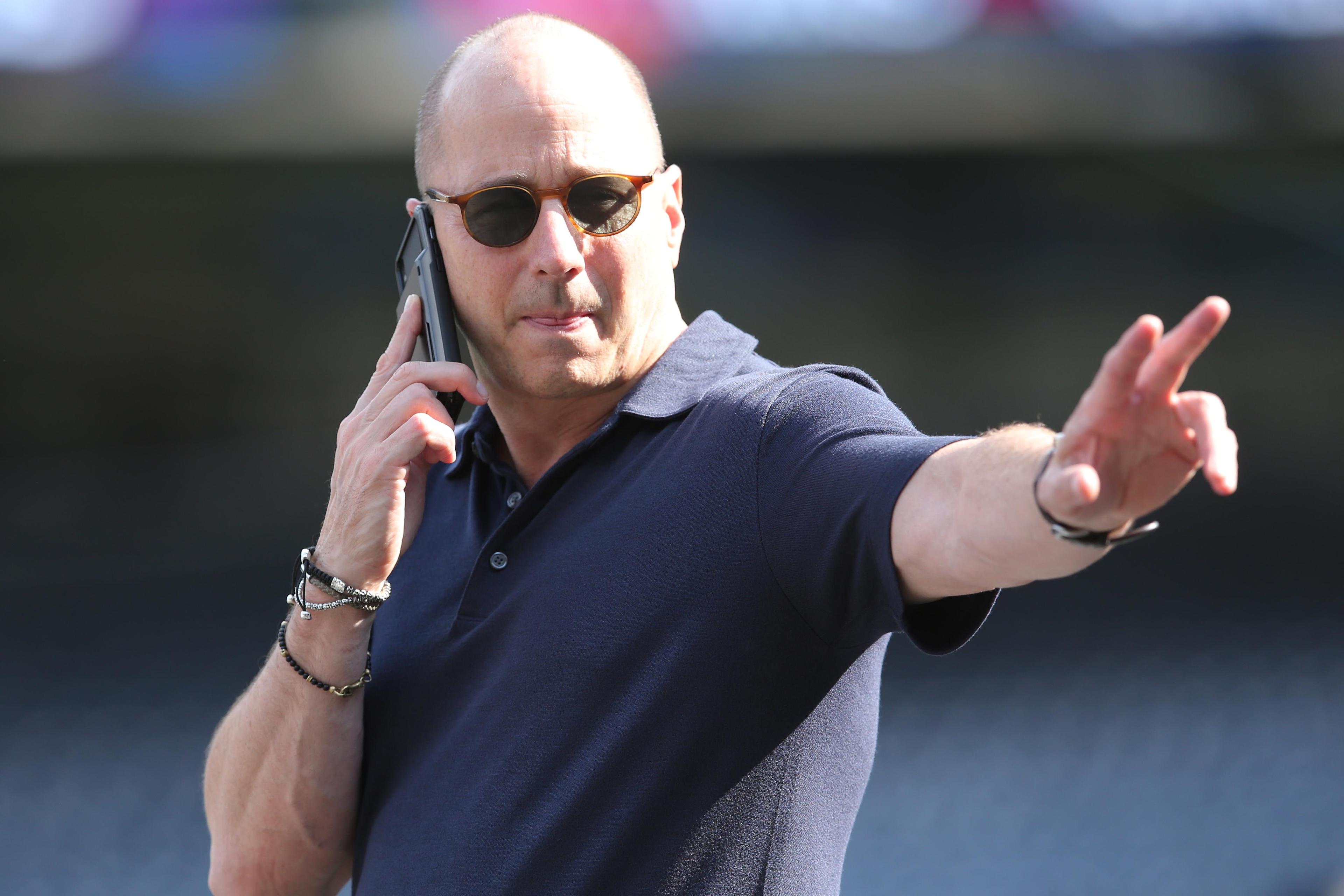 Oct 2, 2019; New York, NY, USA; New York Yankees general manger Brian Cashman gestures while on the phone during a workout day before game 1 of the ALDS at Yankees Stadium. Mandatory Credit: Brad Penner-USA TODAY Sports