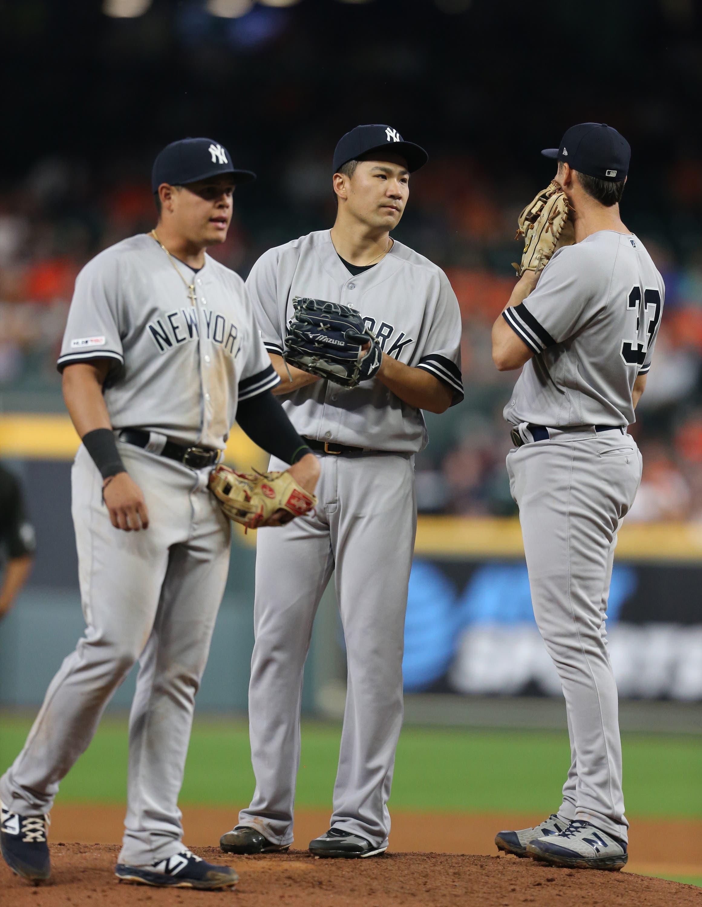 New York Yankees starting pitcher Masahiro Tanaka is joined on the mound by teammates against the Houston Astros in the sixth inning at Minute Maid Park. / Thomas Shea/USA TODAY Sports