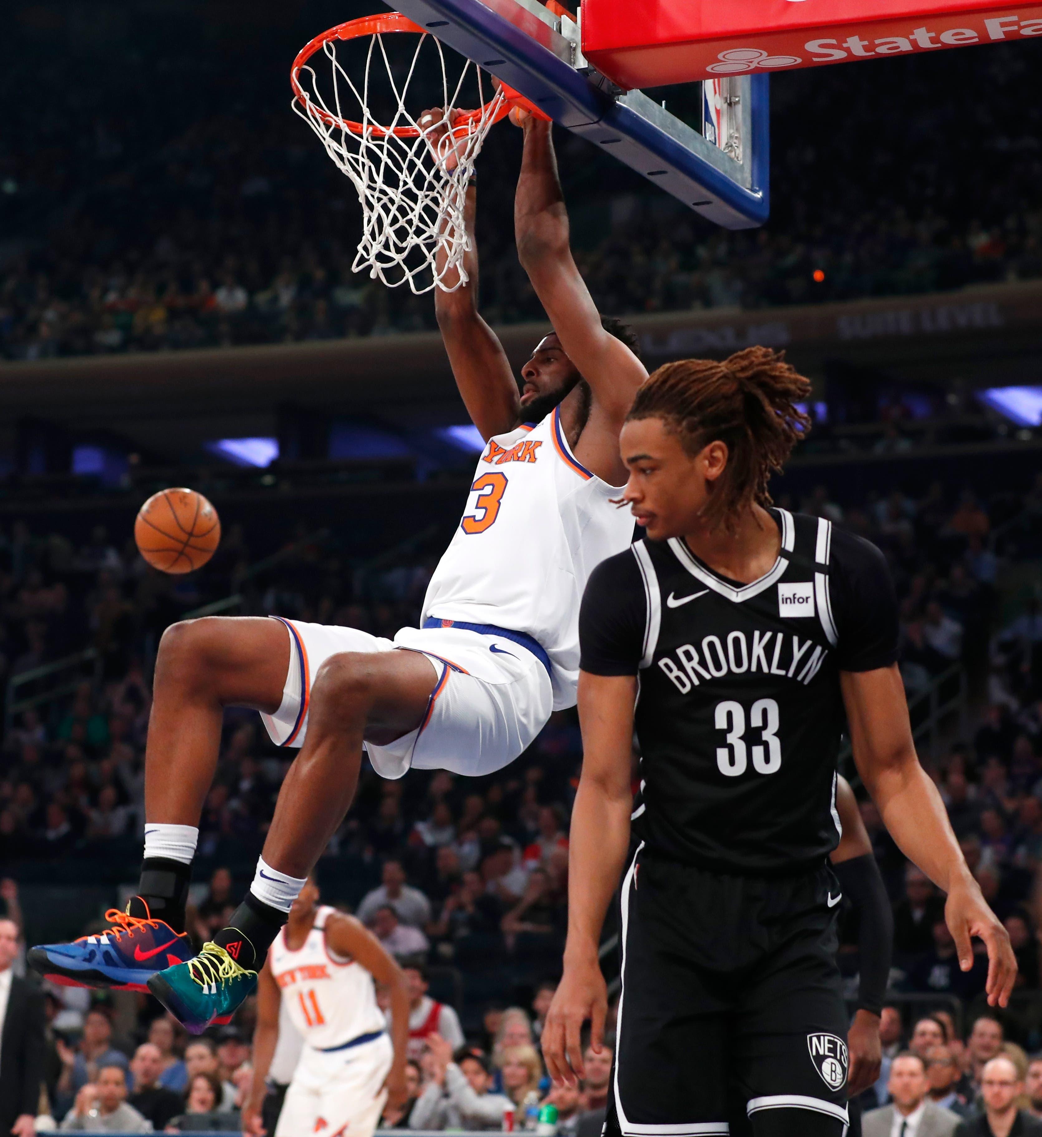 Jan 26, 2020; New York, New York, USA; New York Knicks center Mitchell Robinson (23) dunks against Brooklyn Nets forward Nicolas Claxton (33) during the first half at Madison Square Garden. Mandatory Credit: Noah K. Murray-USA TODAY Sports / Noah K. Murray