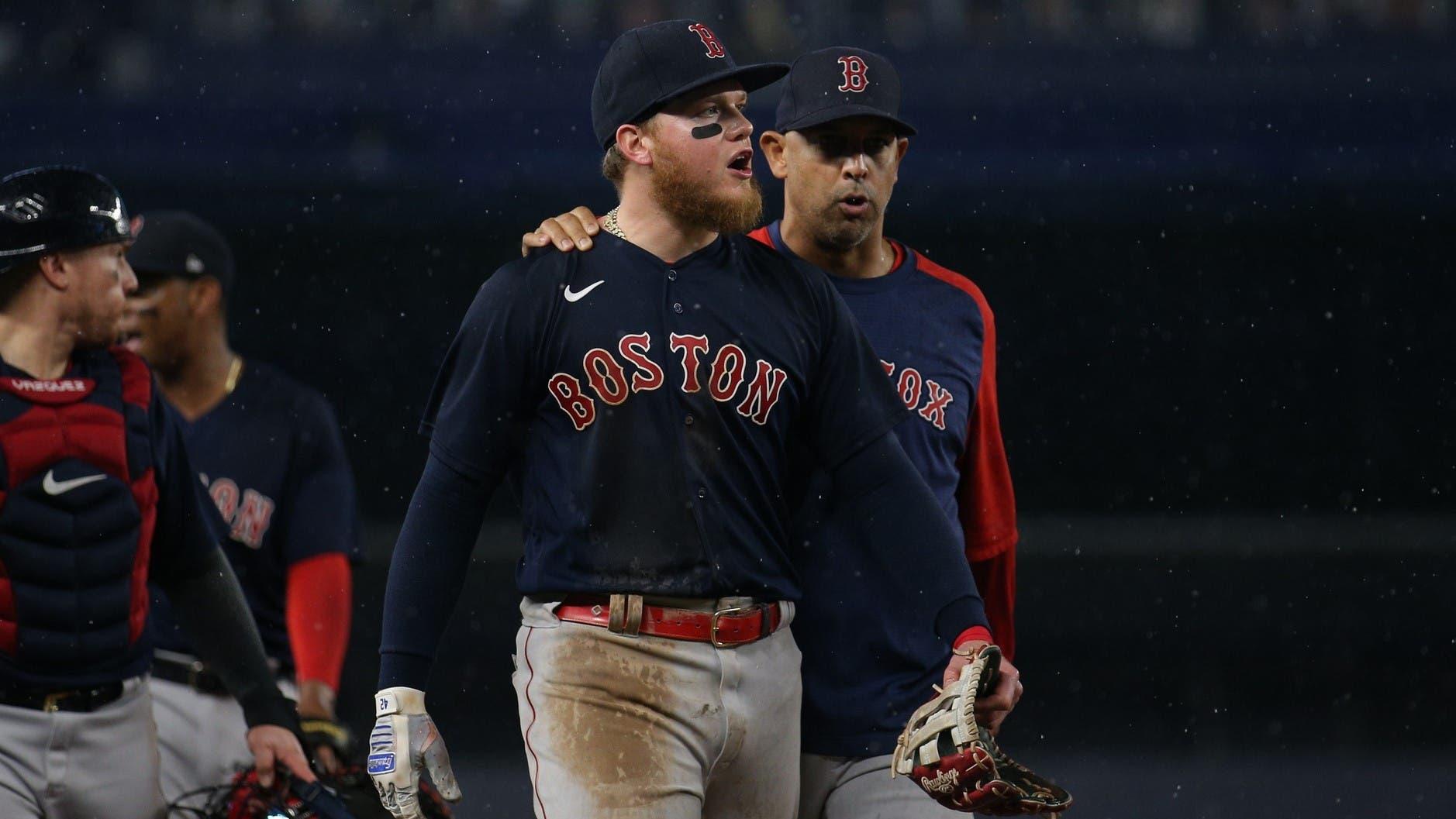 Boston Red Sox left fielder Alex Verdugo (99) is walked off the field by manager Alex Cora (13) after a fan threw an object at him during the sixth inning against the New York Yankees at Yankee Stadium. / Brad Penner-USA TODAY Sports