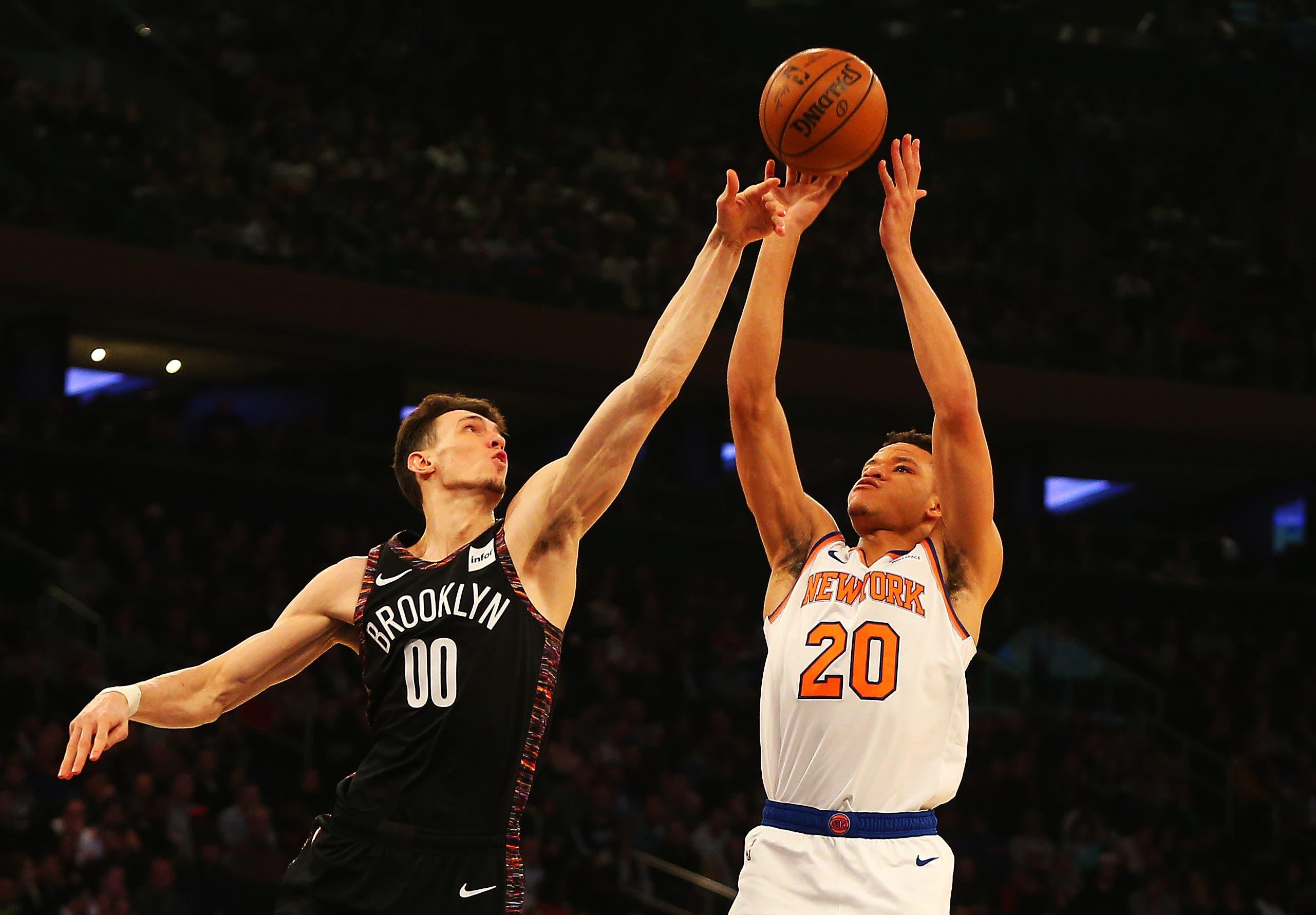 New York Knicks forward Kevin Knox shoots against Brooklyn Nets forward Rodions Kurucs during the first half at Madison Square Garden. / Andy Marlin/USA TODAY Sports