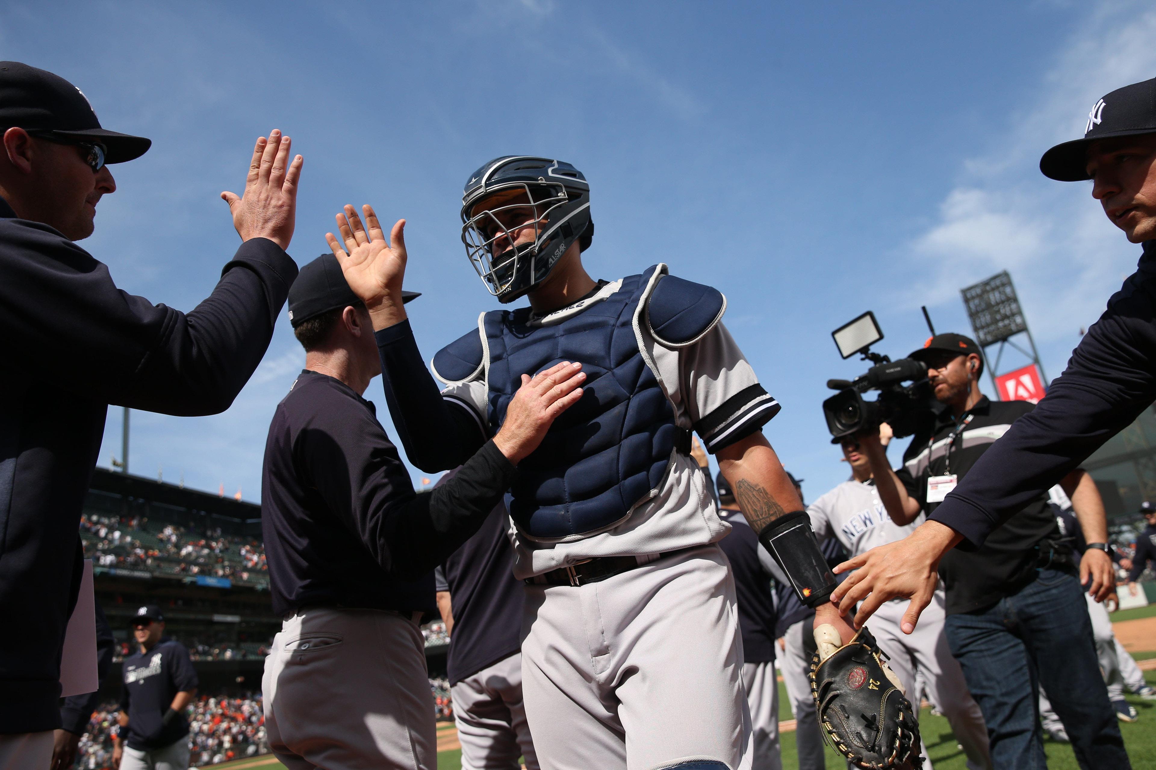 Apr 27, 2019; San Francisco, CA, USA; New York Yankees catcher Gary Sanchez (24) is congratulated by teammates after the Yankees defeated the San Francisco Giants 6-4 at Oracle Park. Mandatory Credit: Cary Edmondson-USA TODAY Sports / Cary Edmondson