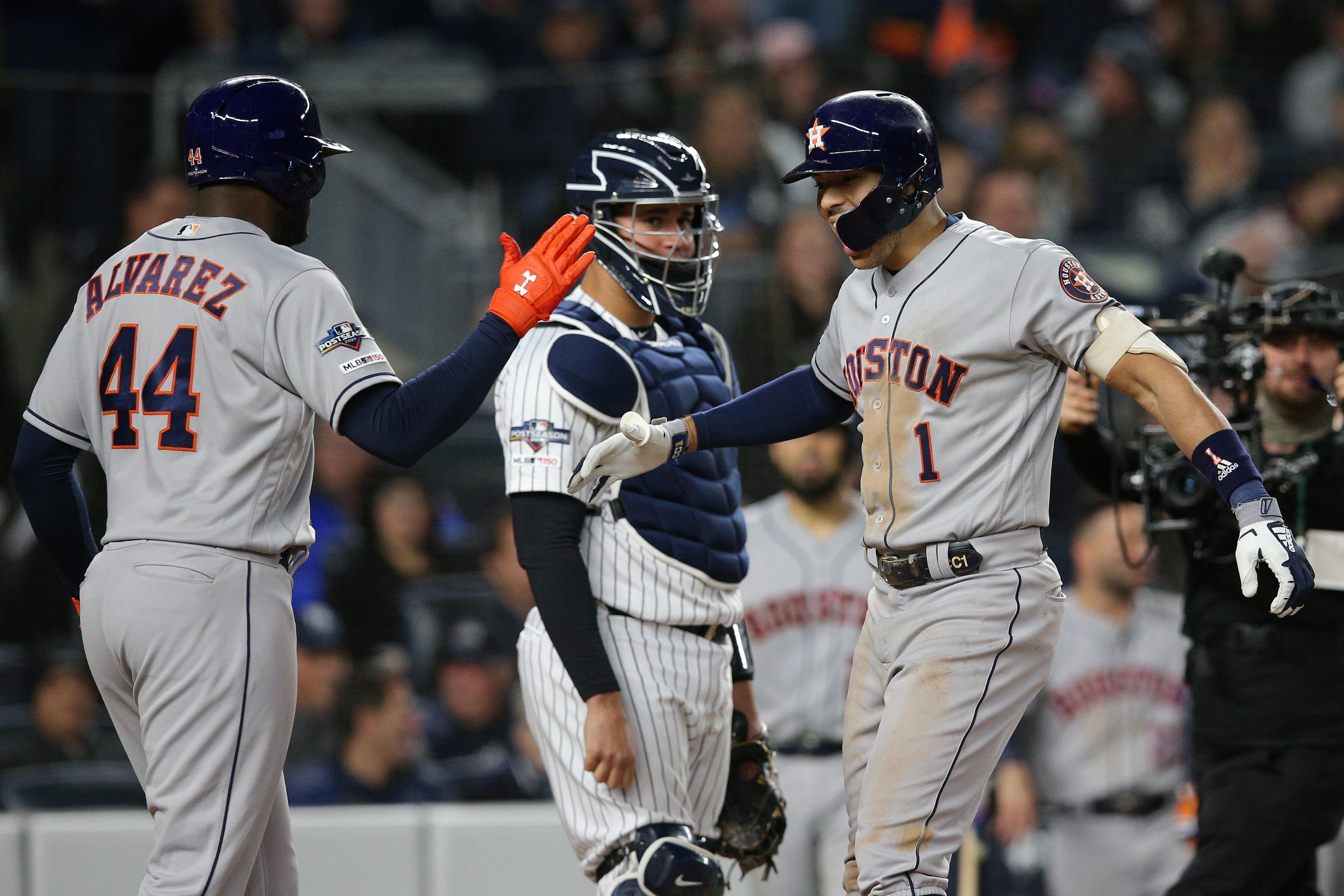 Oct 17, 2019; Bronx, NY, USA; Houston Astros shortstop Carlos Correa (1) celebrates with designated hitter Yordan Alvarez (44) after hitting a three run home run as New York Yankees catcher Gary Sanchez (24) looks on during the sixth inning of game four of the 2019 ALCS playoff baseball series at Yankee Stadium. Mandatory Credit: Brad Penner-USA TODAY Sports / Brad Penner