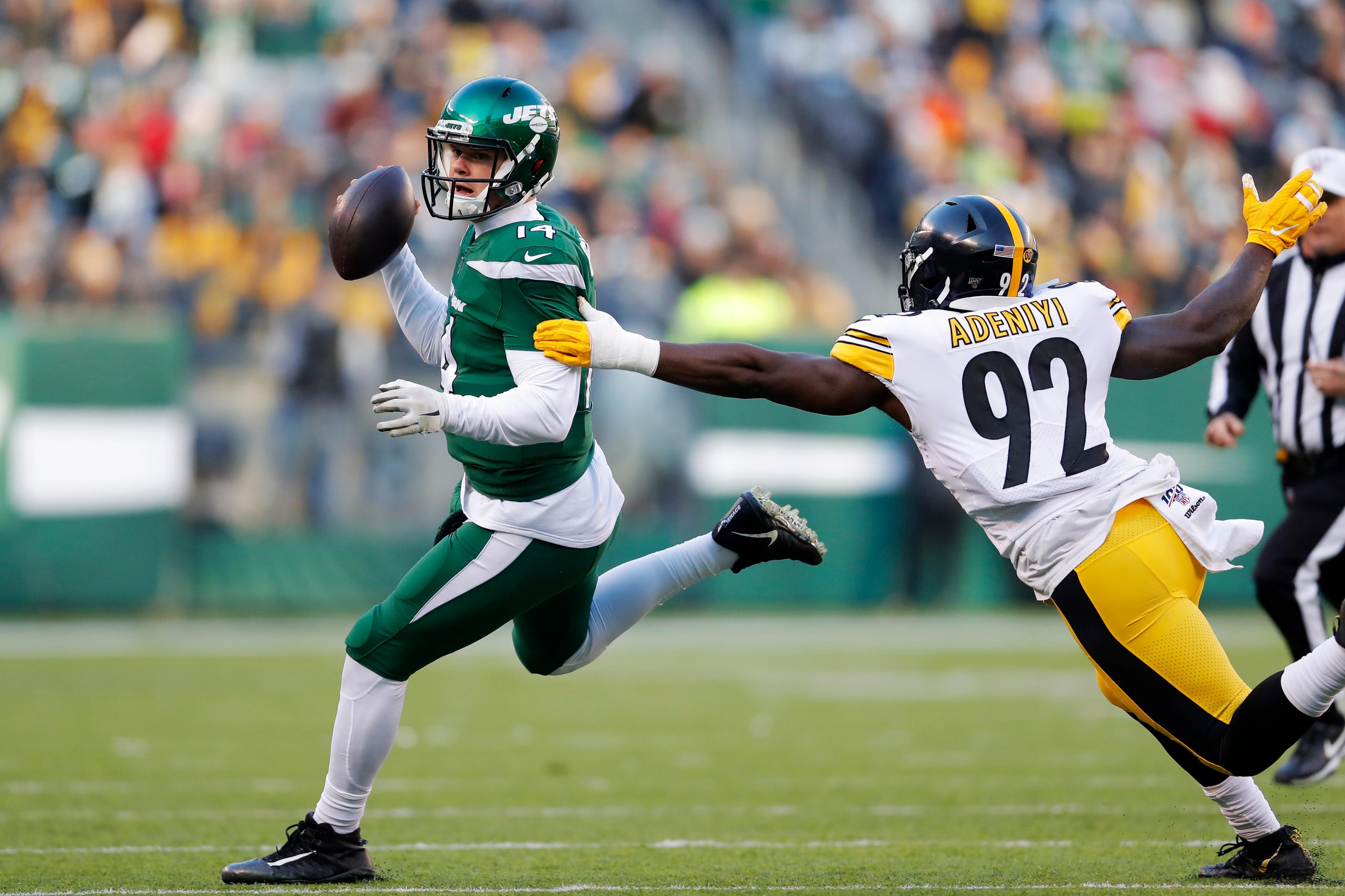 New York Jets quarterback Sam Darnold (14) looks to pass in front of Pittsburgh Steelers linebacker Ola Adeniyi (92) in the second half of an NFL football game, Sunday, Dec. 22, 2019, in East Rutherford, N.J. (AP Photo/Adam Hunger) 