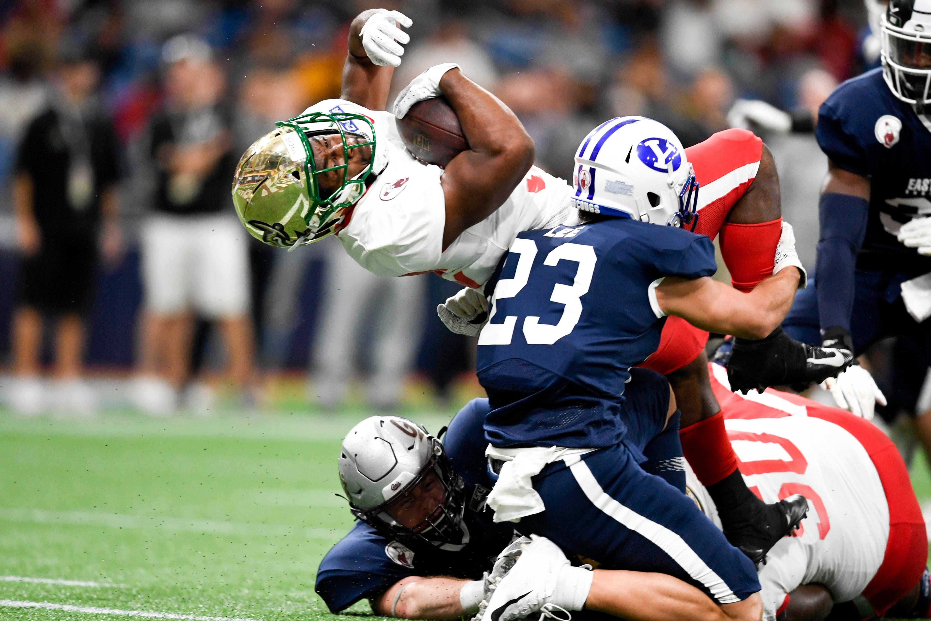 Jan 18, 2020; St. Petersburg, Florida, USA; Team East running back Benny LeMay (32) runs the ball in for a touchdown as Team West safety Austin Lee (23) defends during the first quarter at Tropicana Field. / Douglas DeFelice/USA Today SPORTS