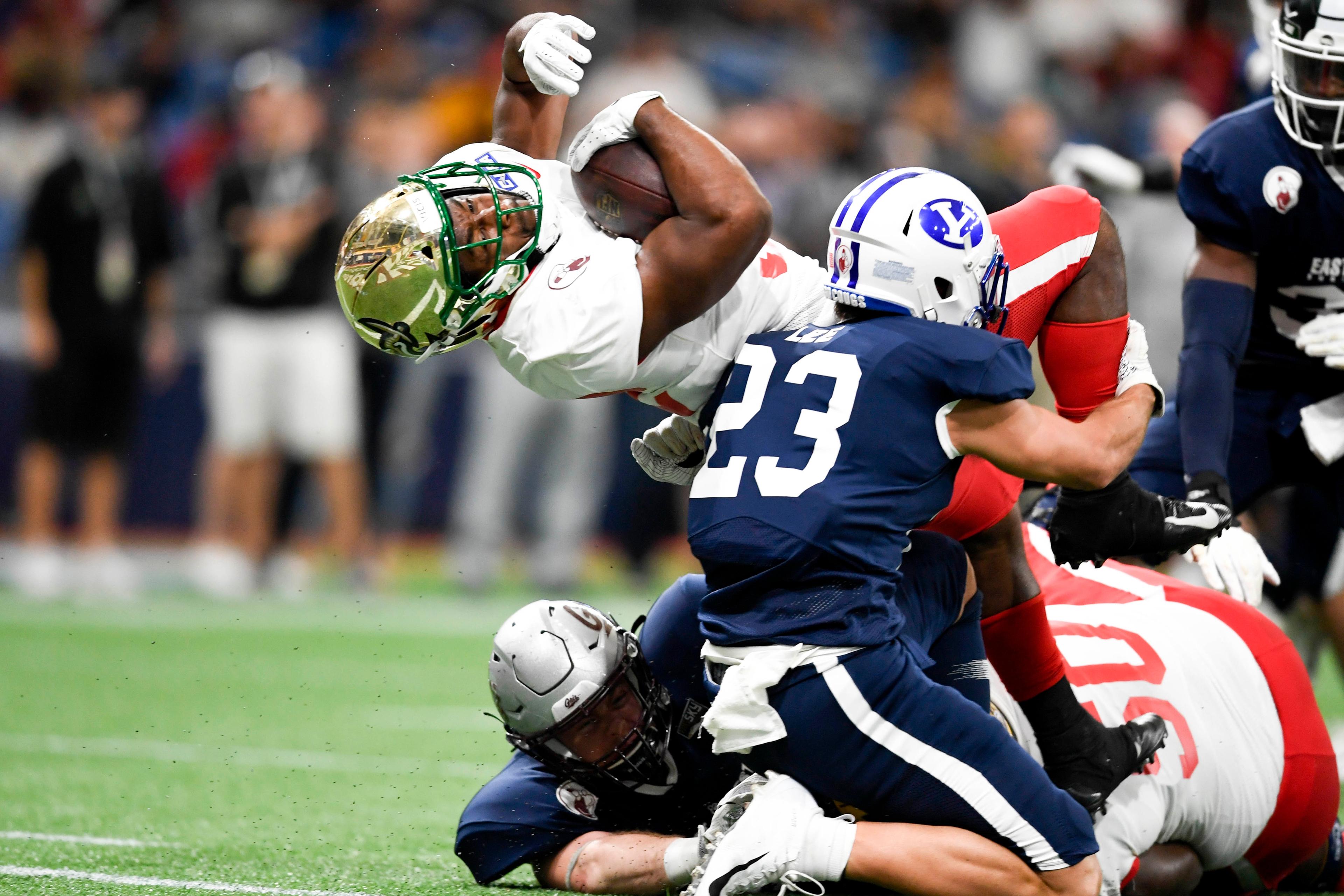 Jan 18, 2020; St. Petersburg, Florida, USA; Team East running back Benny LeMay (32) runs the ball in for a touchdown as Team West safety Austin Lee (23) defends during the first quarter at Tropicana Field.