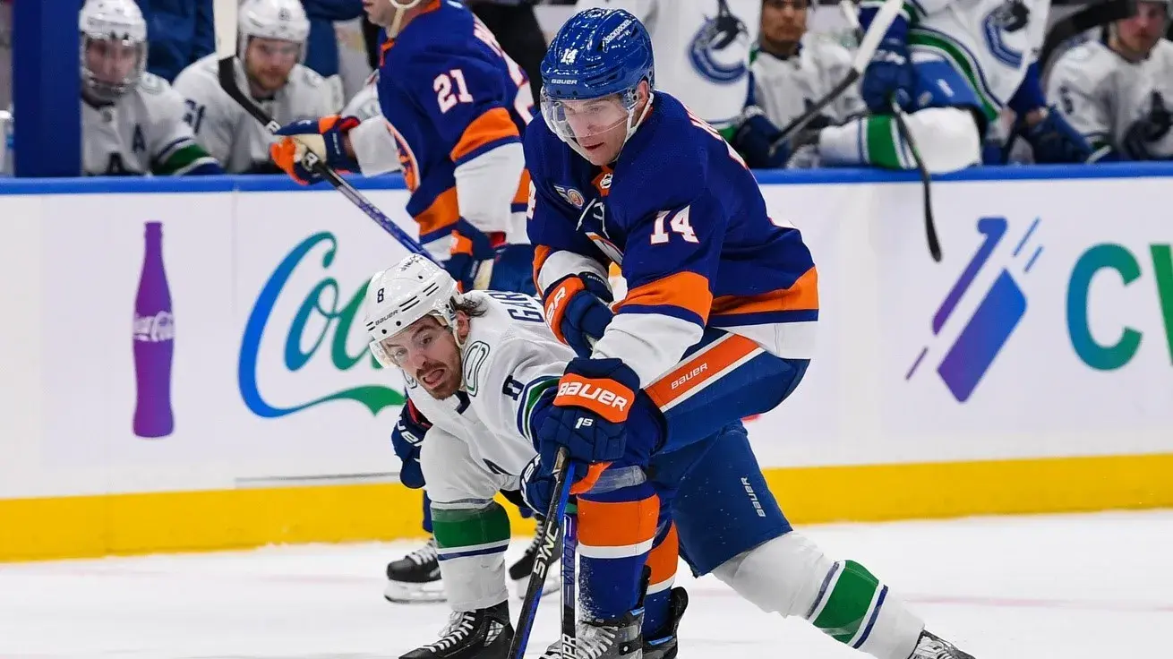 Feb 9, 2023; Elmont, New York, USA; Vancouver Canucks right wing Conor Garland (8) defends against New York Islanders center Bo Horvat (14) during the second period at UBS Arena / Dennis Schneidler-USA TODAY Sports