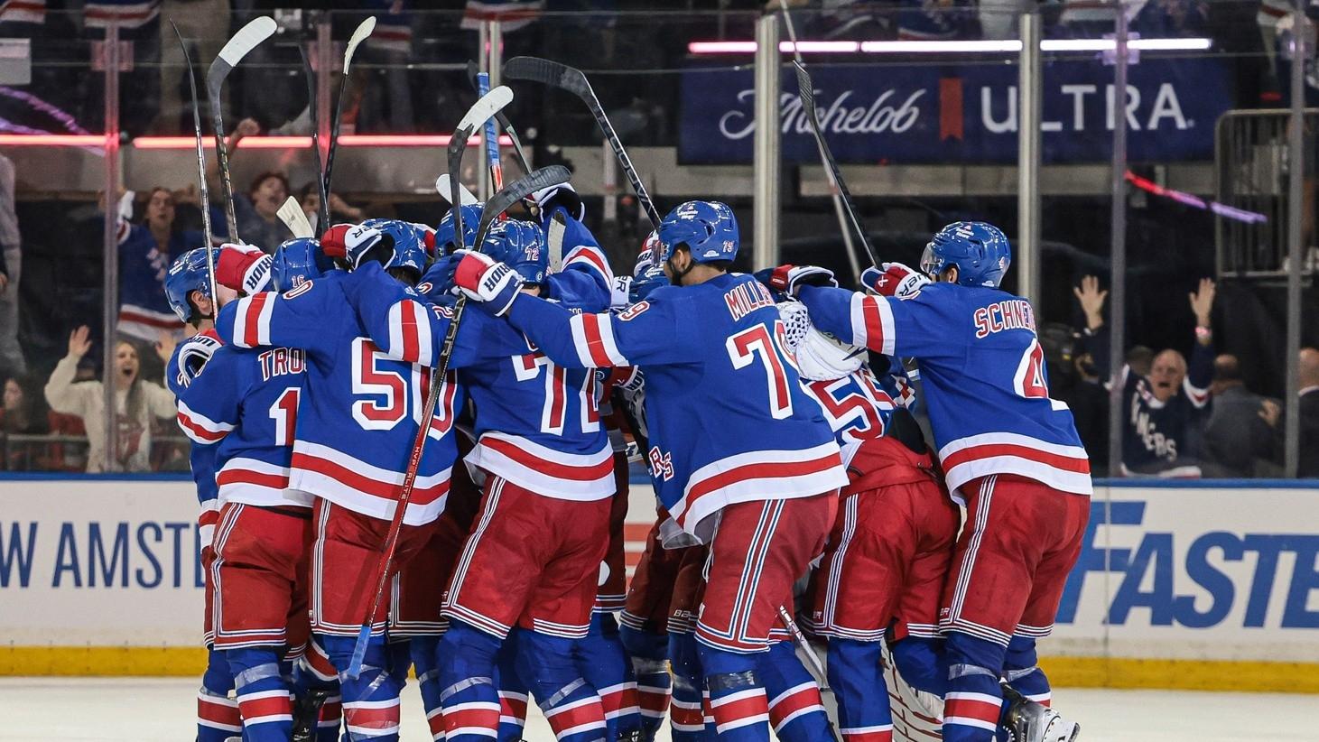 New York Rangers center Barclay Goodrow (21) celebrates his game-winning overtime goal with teammates in game two of the Eastern Conference Final of the 2024 Stanley Cup Playoffs against the Florida Panthers at Madison Square Garden.