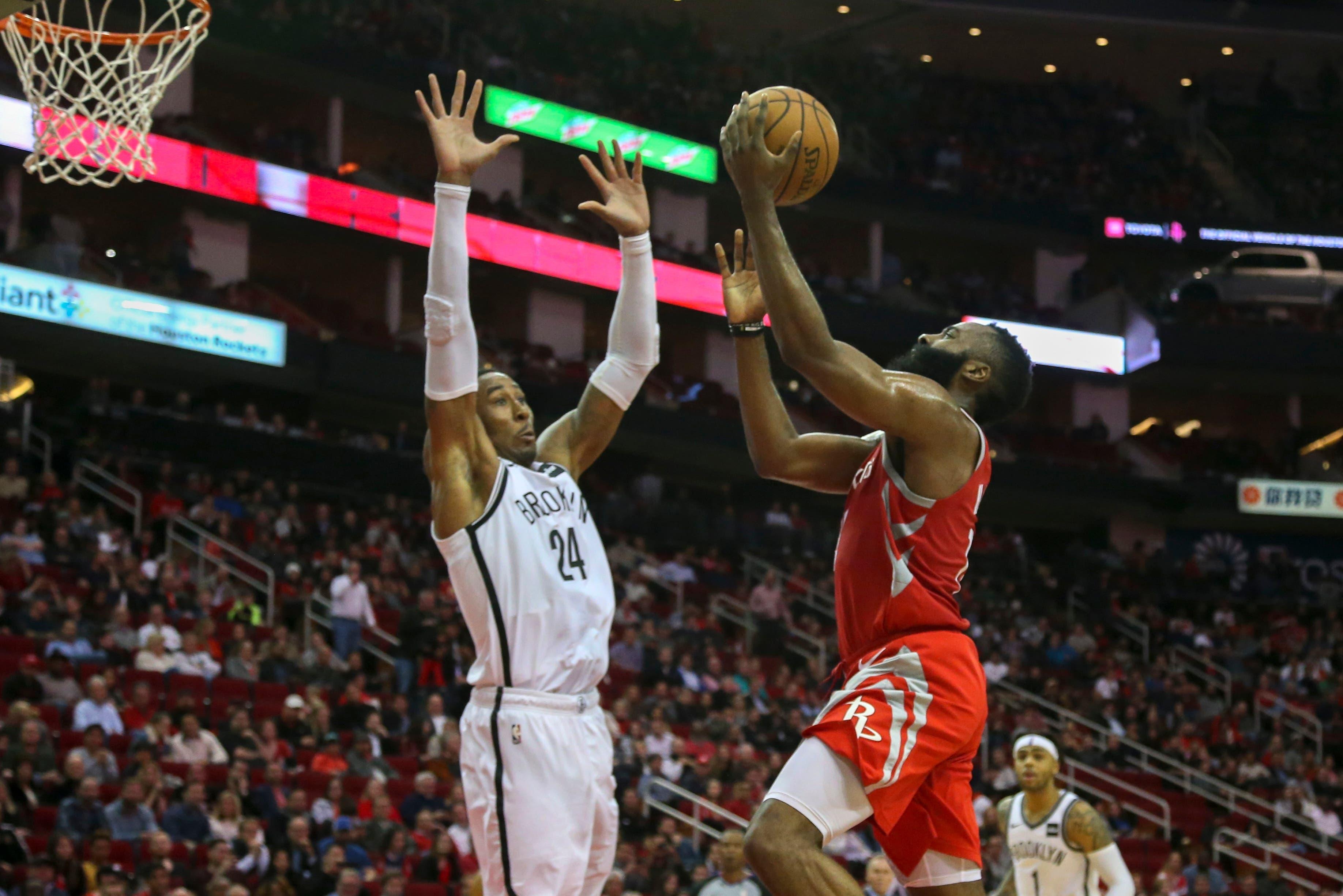 Jan 16, 2019; Houston, TX, USA; Houston Rockets guard James Harden (13) goes up for a layup over Brooklyn Nets forward Rondae Hollis-Jefferson (24) during the third quarter at Toyota Center. Mandatory Credit: John Glaser-USA TODAY Sports / John Glaser