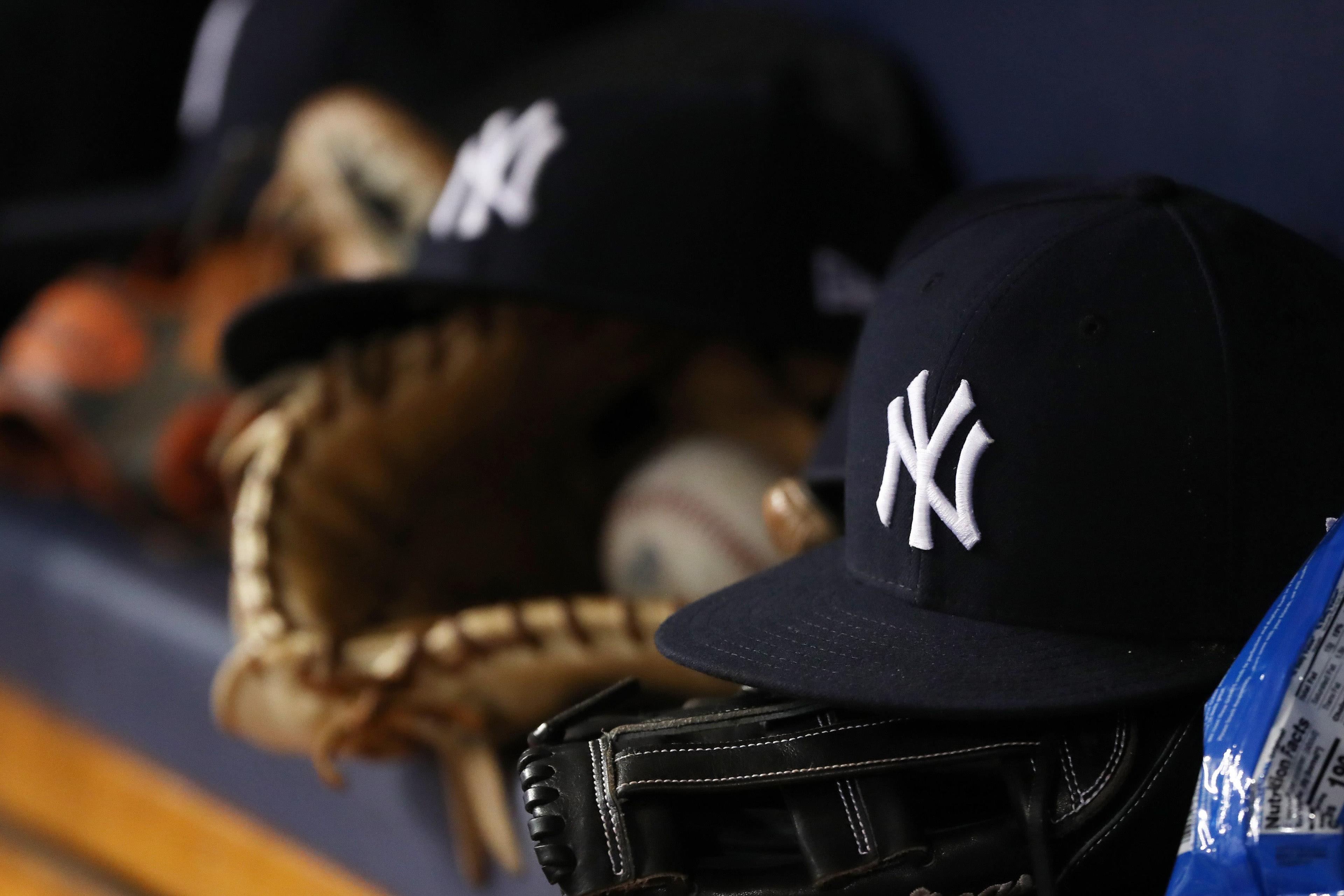 Jun 22, 2018; St. Petersburg, FL, USA; A general view of New York Yankees hat and glove laying in the dugout at Tropicana Field. Mandatory Credit: Kim Klement-USA TODAY Sports / Kim Klement