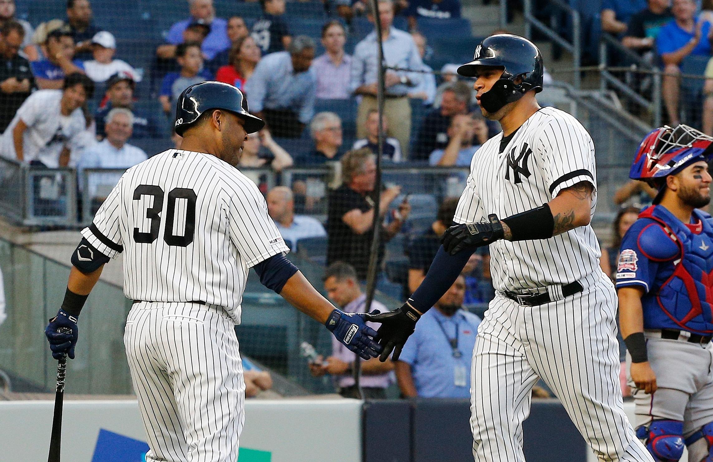 Sep 3, 2019; Bronx, NY, USA; New York Yankees catcher Gary Sanchez (right) is congratulated by designated hitter Edwin Encarnacion (30) after hitting a two run home run against the Texas Rangers during the first inning at Yankee Stadium. Mandatory Credit: Andy Marlin-USA TODAY Sports