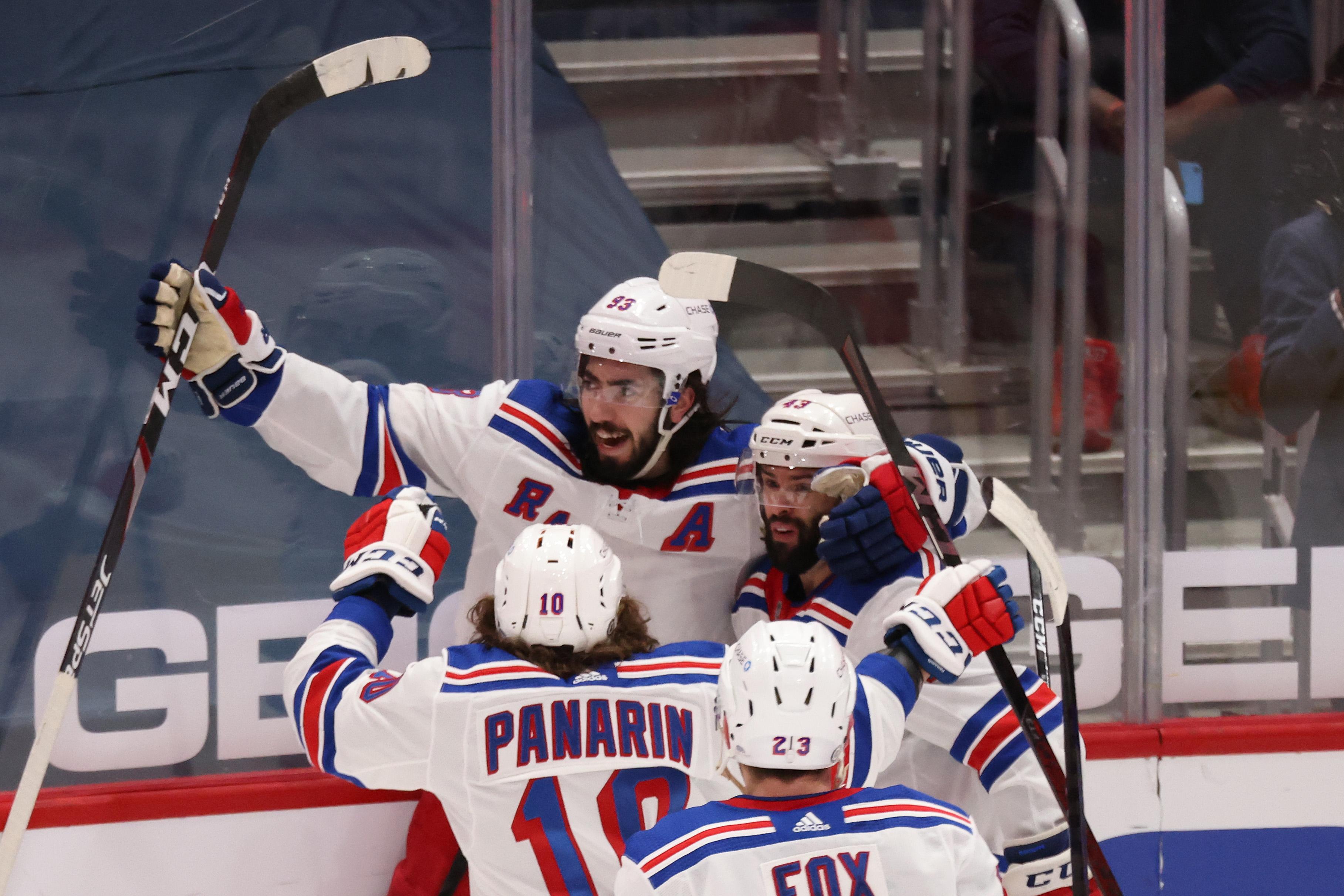 Mar 20, 2021; Washington, District of Columbia, USA; New York Rangers center Mika Zibanejad (93) celebrates with teammates after scoring the go ahead goal against the Washington Capitals late in the third period at Capital One Arena. Mandatory Credit: Geoff Burke-USA TODAY Sports