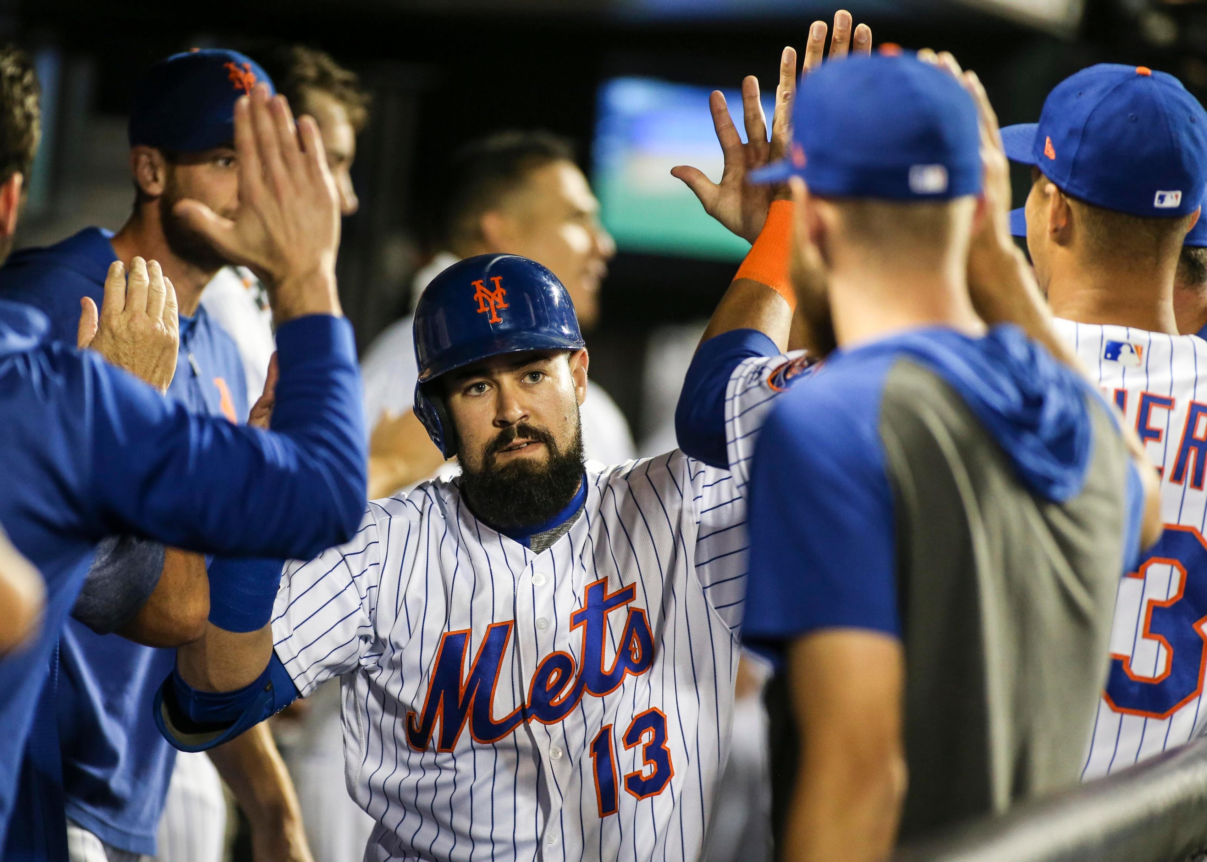 Aug 10, 2019; New York City, NY, USA; New York Mets infielder Luis Guillorme (13) is greeted in the dugout after hitting a pinch hit game tying solo home run in the eighth inning against the Washington Nationals at Citi Field. Mandatory Credit: Wendell Cruz-USA TODAY Sports