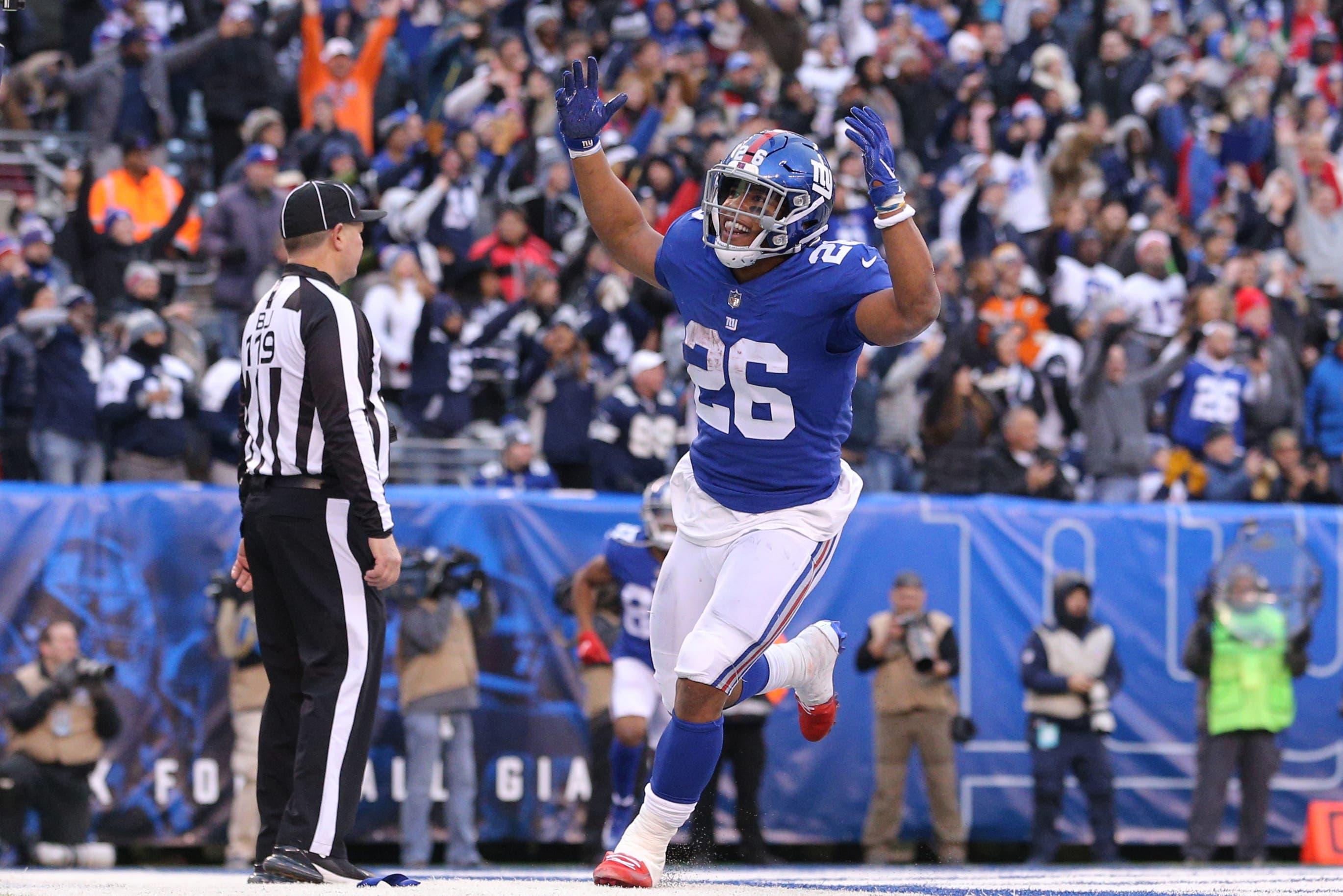 Dec 30, 2018; East Rutherford, NJ, USA; New York Giants running back Saquon Barkley (26) celebrates after scoring a touchdown against the Dallas Cowboys during the fourth quarter at MetLife Stadium. Mandatory Credit: Brad Penner-USA TODAY Sports / Brad Penner