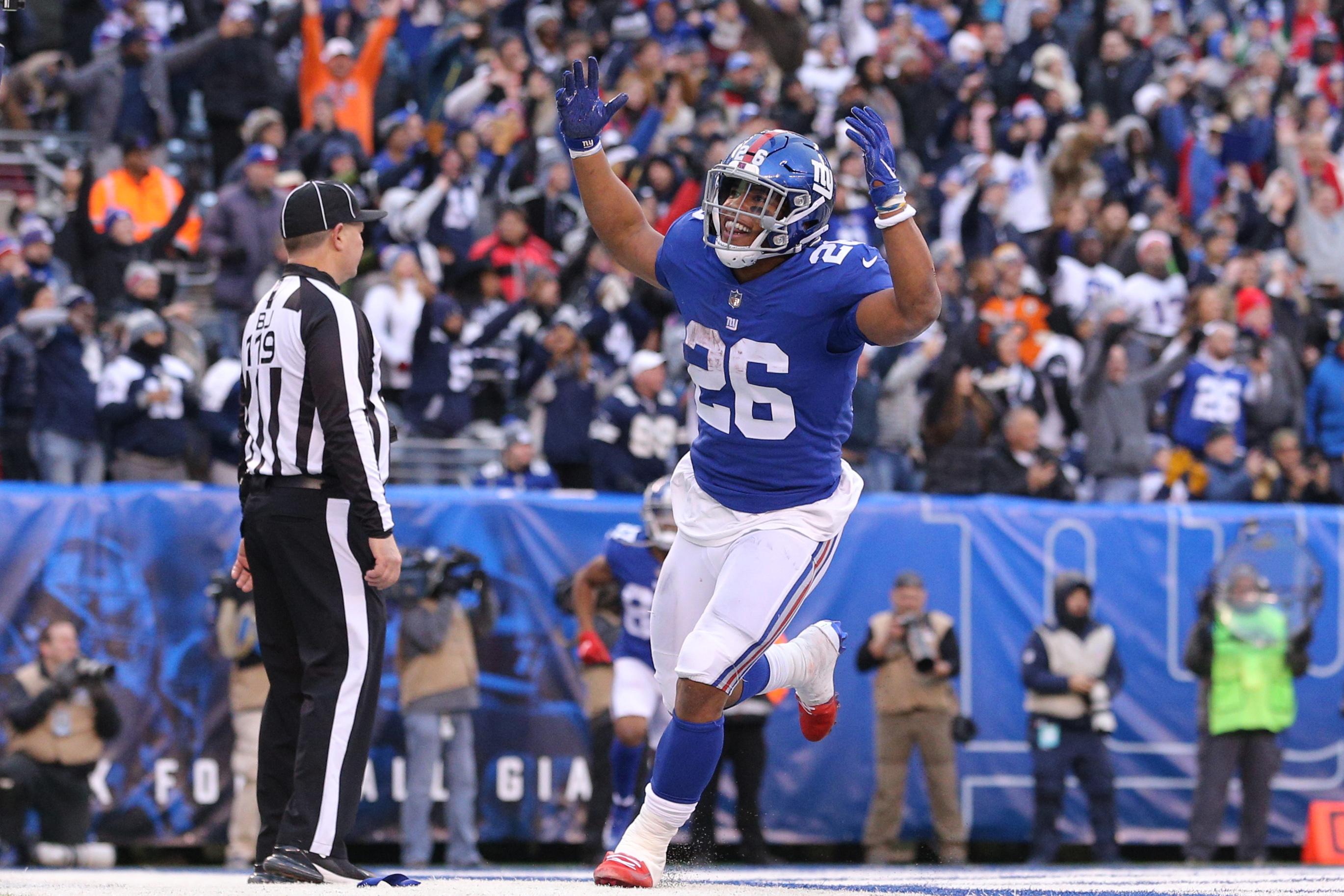 Dec 30, 2018; East Rutherford, NJ, USA; New York Giants running back Saquon Barkley (26) celebrates after scoring a touchdown against the Dallas Cowboys during the fourth quarter at MetLife Stadium. Mandatory Credit: Brad Penner-USA TODAY Sports