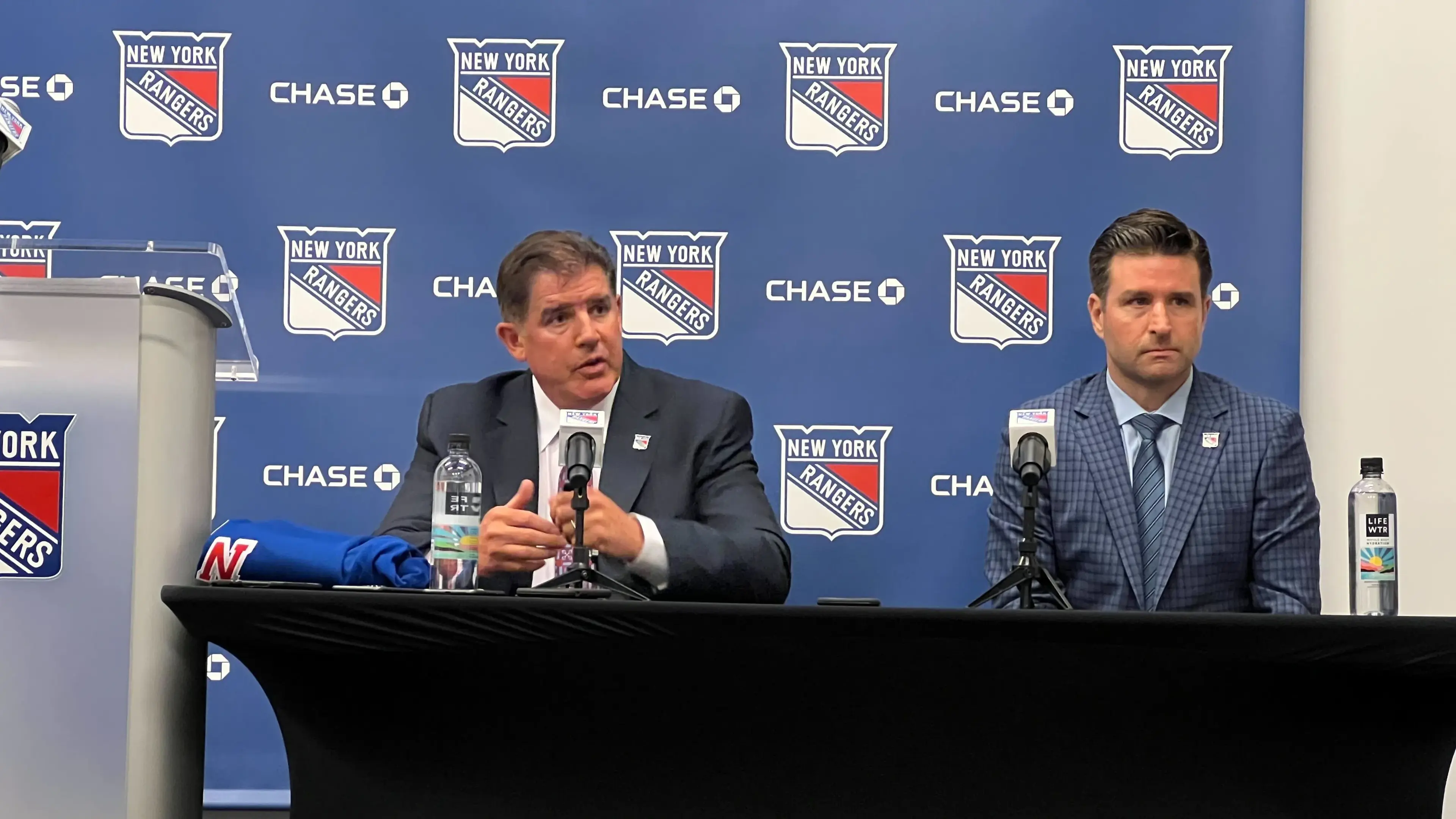 Peter Laviolette speaks to the media alongside Chris Drury at his introductory press conference as the head coach of the New York Rangers. / Conor Byrne - SNY