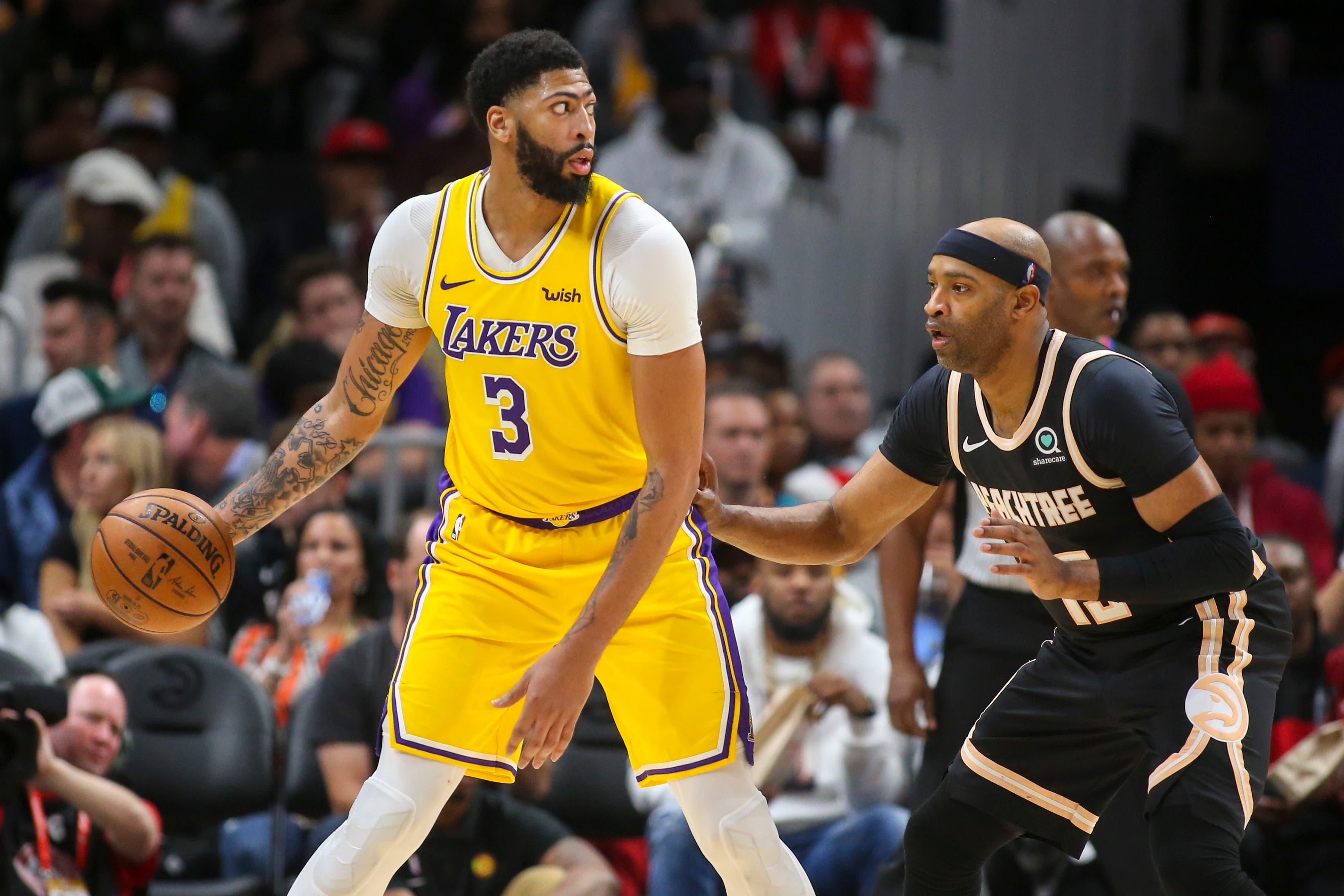 Dec 15, 2019; Atlanta, GA, USA; Los Angeles Lakers forward Anthony Davis (3) is defended by Atlanta Hawks guard Vince Carter (15) in the second half at State Farm Arena. Mandatory Credit: Brett Davis-USA TODAY Sports / Brett Davis