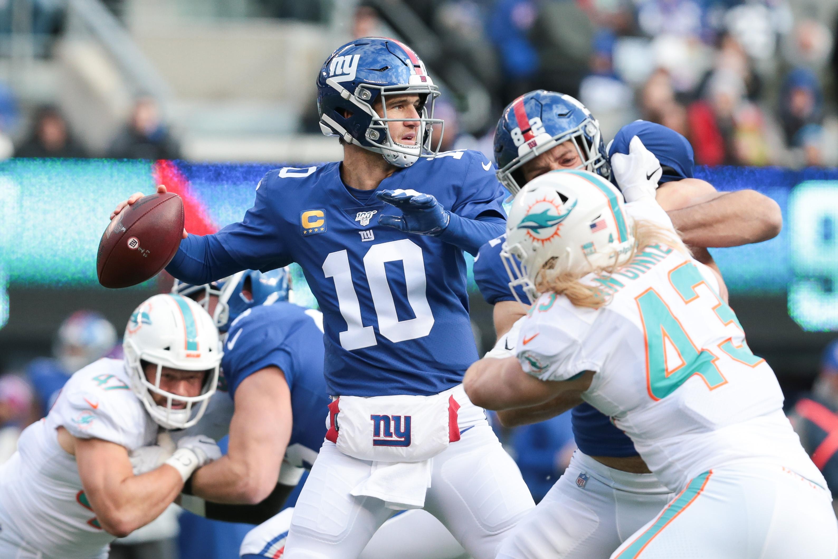 Dec 15, 2019; East Rutherford, NJ, USA; New York Giants quarterback Eli Manning (10) throws a pass during the first quarter as New York Giants linebacker Chris Peace (43) defends at MetLife Stadium. Mandatory Credit: Vincent Carchietta-USA TODAY Sports