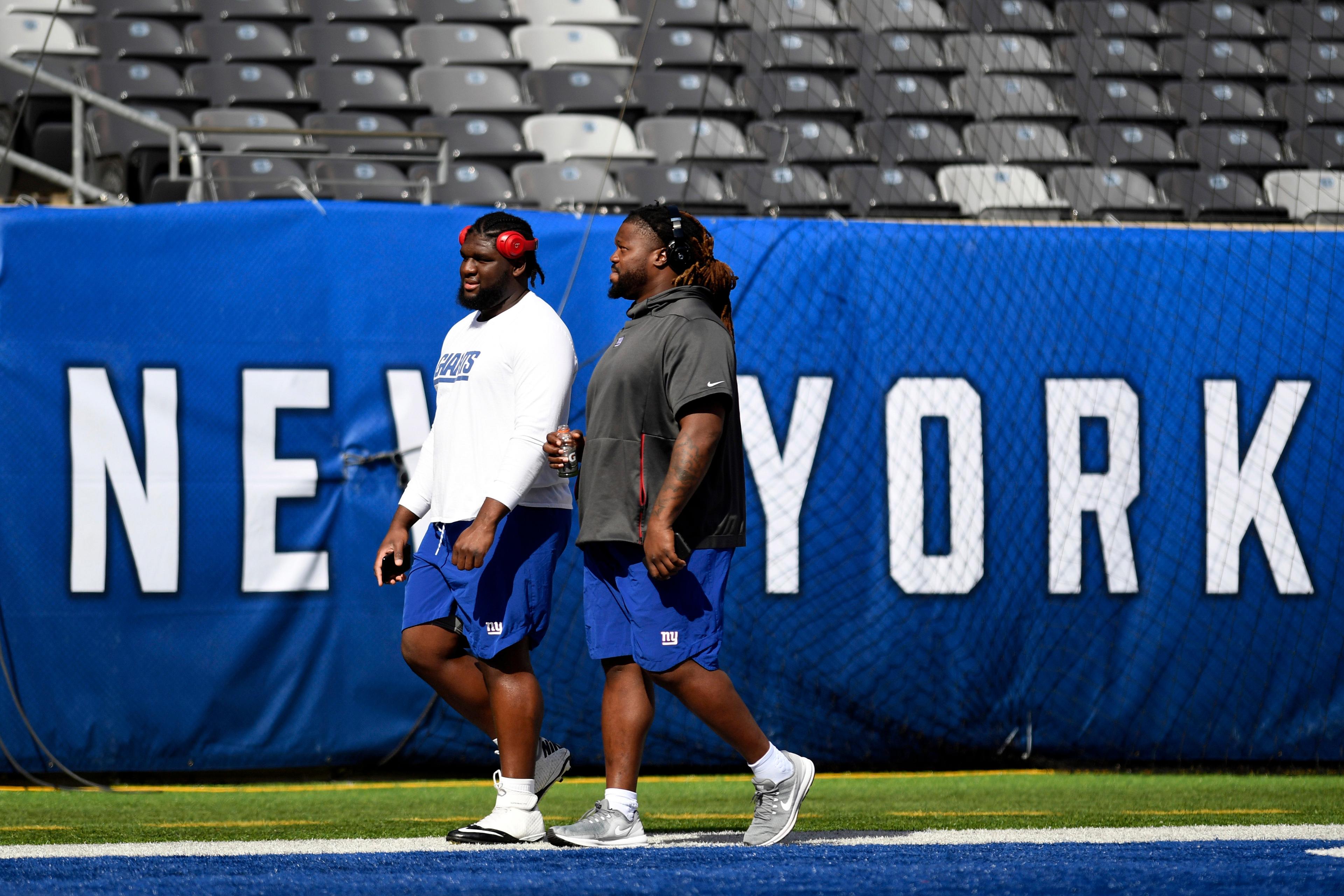 Sep 30, 2018; East Rutherford, NJ, USA; New York Giants defensive tackle Dalvin Tomlinson, left, and defensive tackle Damon Harrison walk on the field before facing the New Orleans Saints at MetLife Stadium. Mandatory Credit: Danielle Parhizkaran/NorthJersey.com via USA TODAY NETWORK