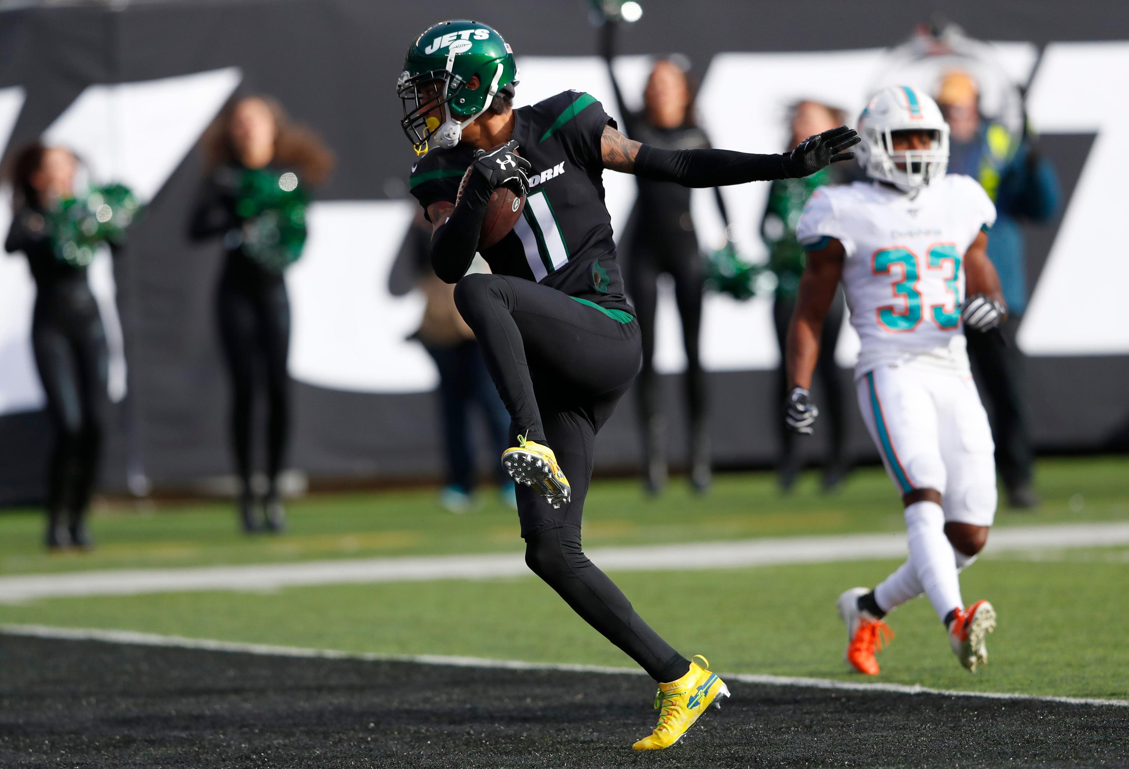 Dec 8, 2019; East Rutherford, NJ, USA; New York Jets wide receiver Robby Anderson (11) scores a touchdown against Miami Dolphins cornerback Jomal Wiltz (33) during the first half at MetLife Stadium. Mandatory Credit: Noah K. Murray-USA TODAY Sports / Noah K. Murray