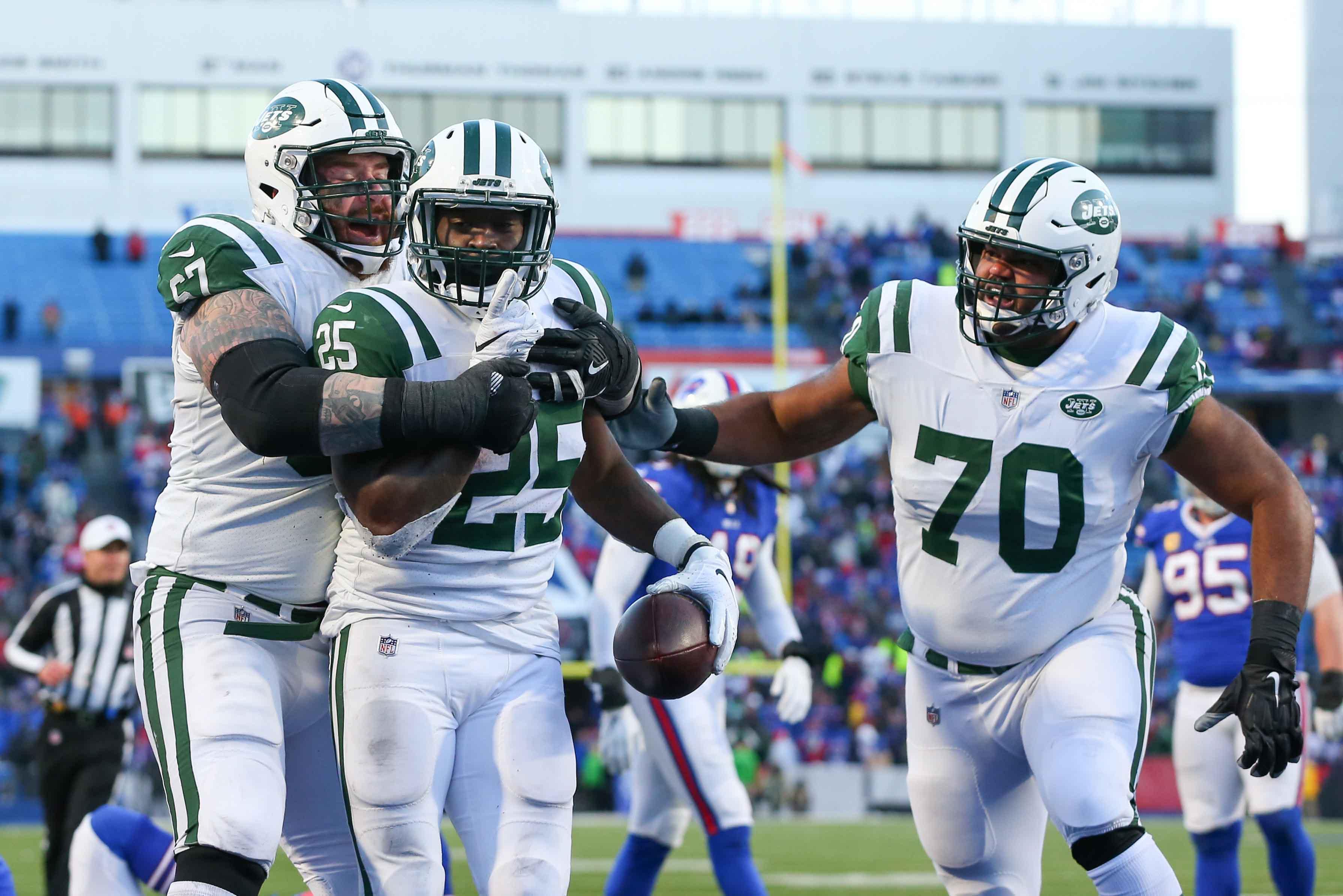 New York Jets running back Elijah McGuire celebrates his game-winning touchdown with offensive guard Brian Winters and offensive guard Dakota Dozier against the Buffalo Bills during the fourth quarter at New Era Field. / Rich Barnes/USA TODAY Sports