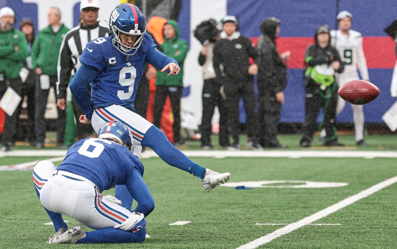 New York Giants place kicker Graham Gano (9) kicks a field goal as punter Jamie Gillan (6) holds during the first half against the New York Jets at MetLife Stadium.