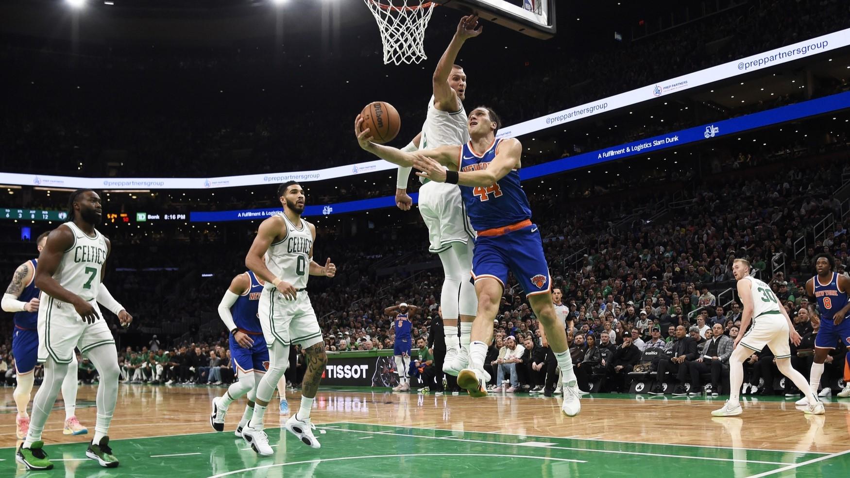 Apr 11, 2024; Boston, Massachusetts, USA; New York Knicks forward Bojan Bogdanovic (44) drives to the basket past Boston Celtics center Kristaps Porzingis (8) during the first half at TD Garden. / Bob DeChiara-USA TODAY Sports