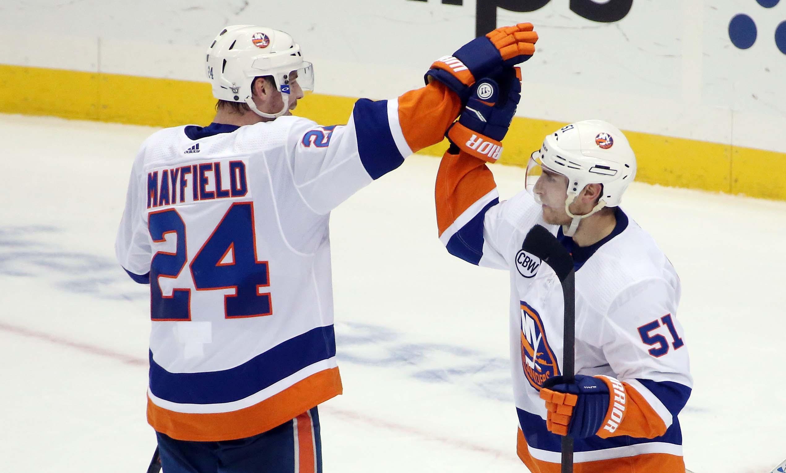 New York Islanders defenseman Scott Mayfield and center Valtteri Filppula high-five after defeating the Pittsburgh Penguins in Game 4 of the first round of the 2019 Stanley Cup Playoffs at PPG PAINTS Arena.