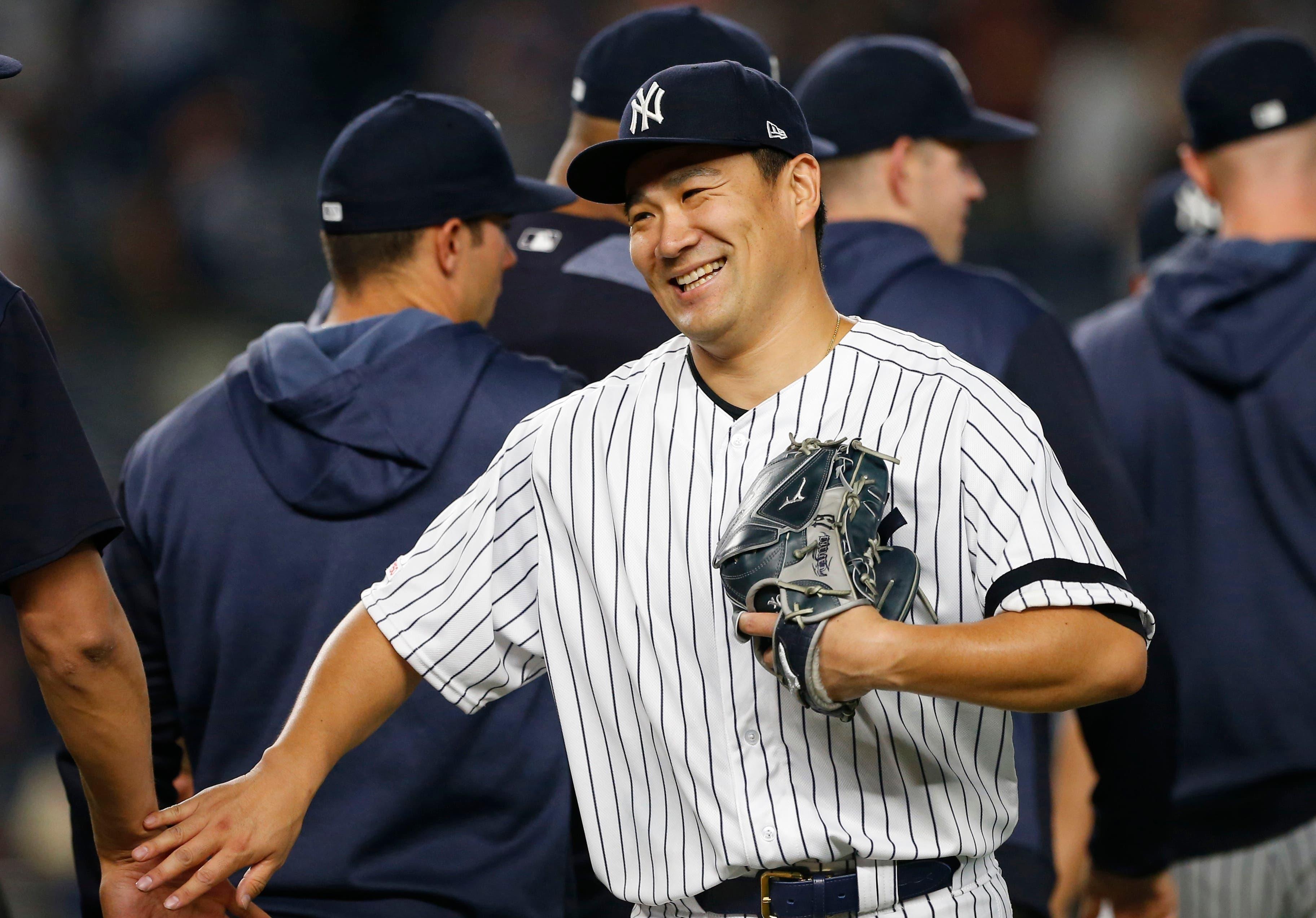 New York Yankees starting pitcher Masahiro Tanaka smiles after pitching a complete game against the Tampa Bay Rays at Yankee Stadium. / Noah K. Murray/USA TODAY Sports