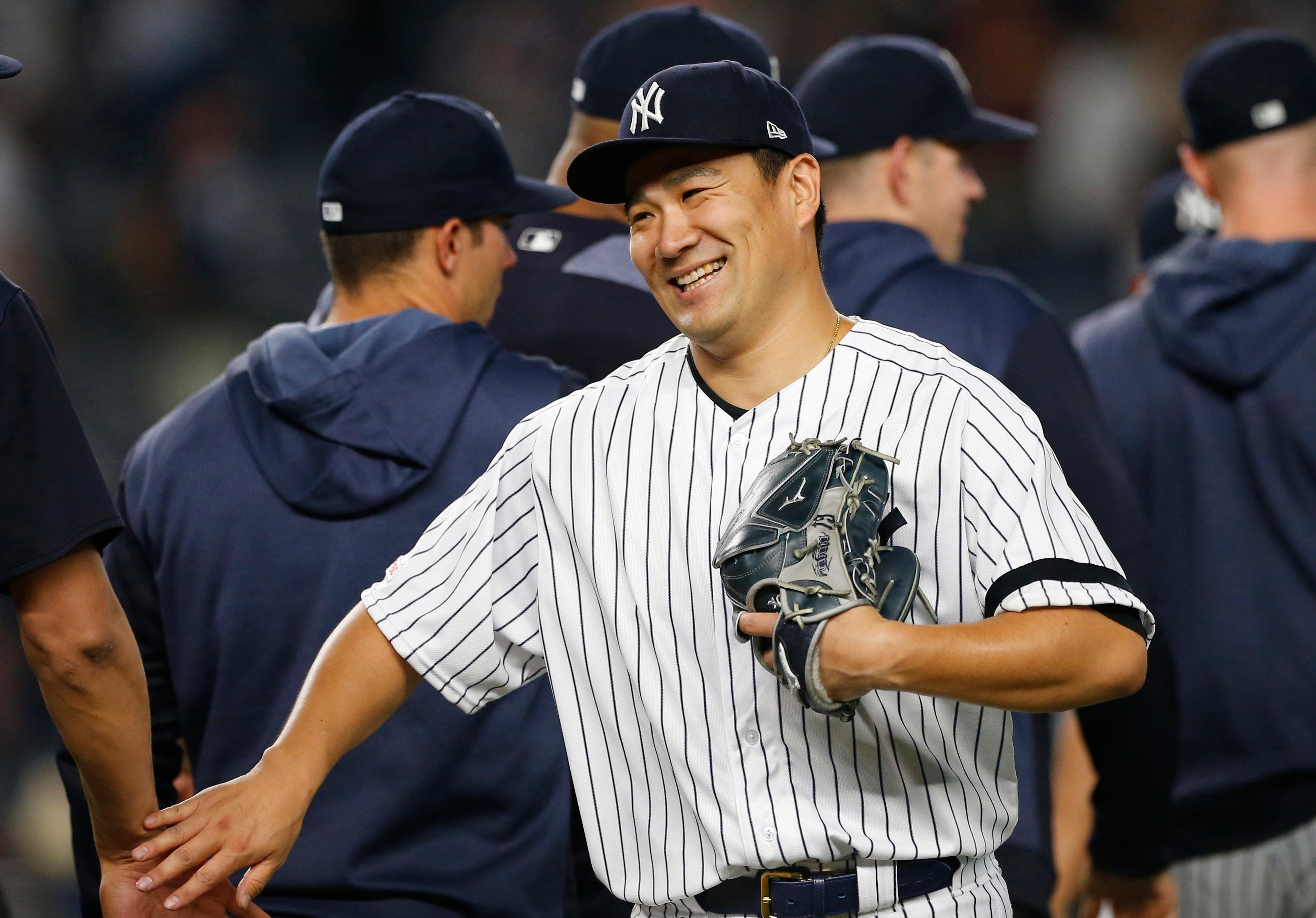 New York Yankees starting pitcher Masahiro Tanaka smiles after pitching a complete game against the Tampa Bay Rays at Yankee Stadium.