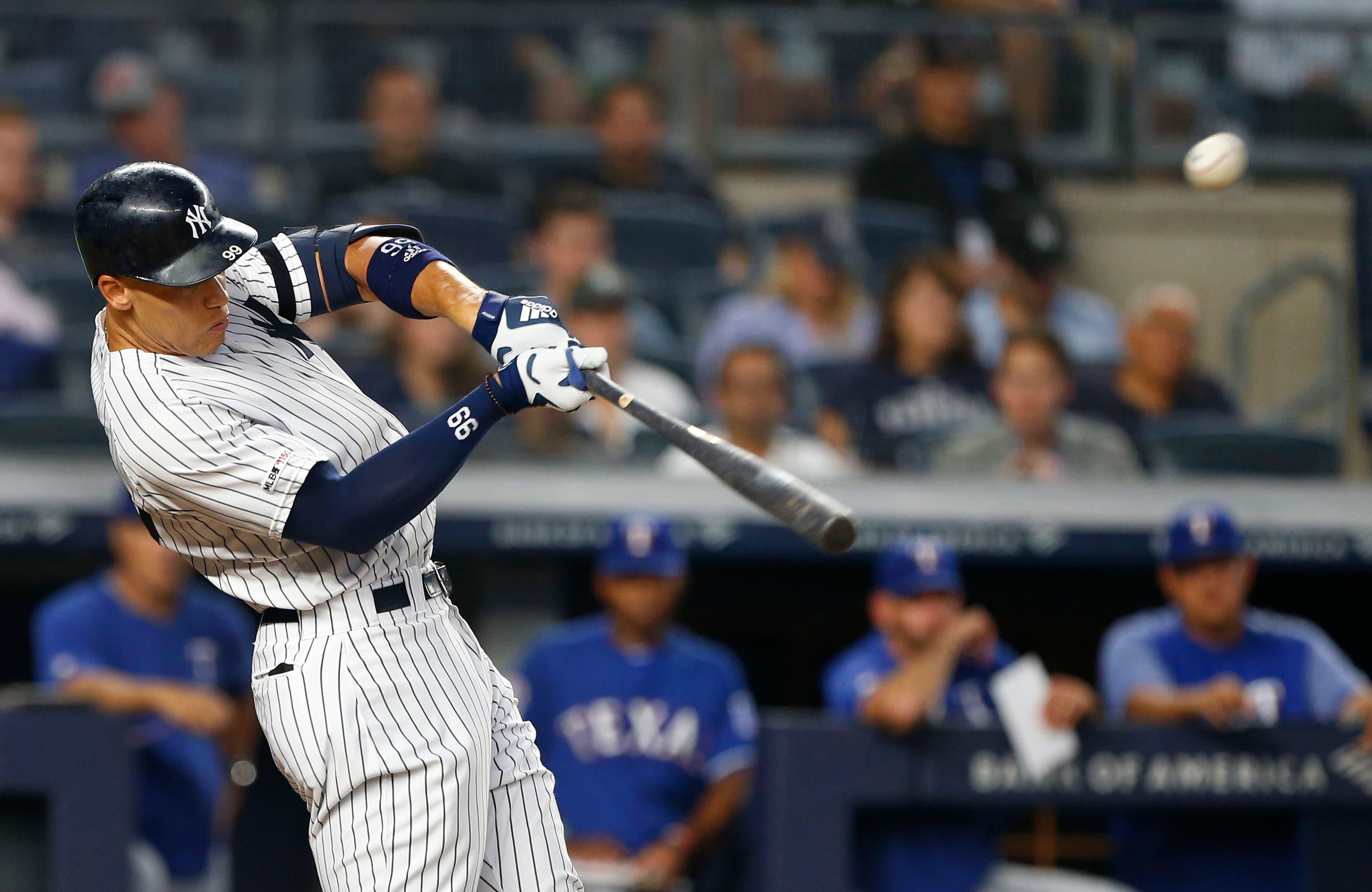 Sep 4, 2019; Bronx, NY, USA; New York Yankees right fielder Aaron Judge (99) hits a two run home run in the third inning against the Texas Rangers at Yankee Stadium. Mandatory Credit: Noah K. Murray-USA TODAY Sports / Noah K. Murray