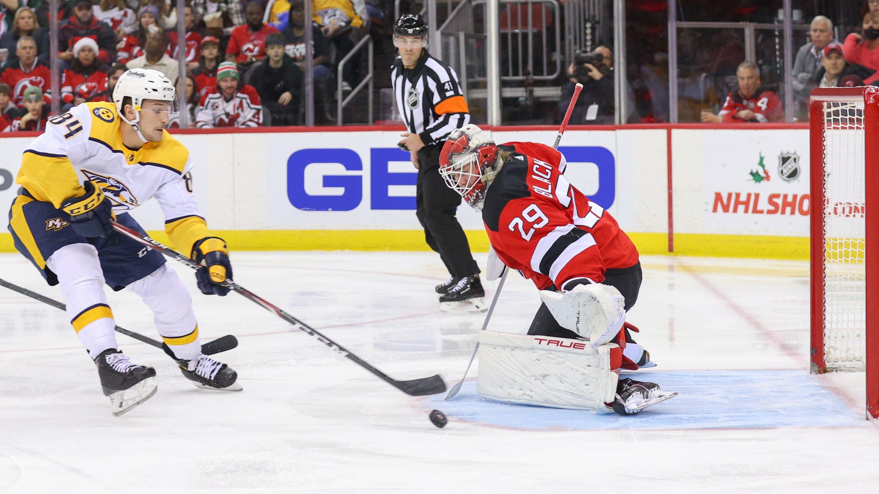 Dec 10, 2021; Newark, New Jersey, USA; Nashville Predators left wing Tanner Jeannot (84) shoots the puck wide of New Jersey Devils goaltender Mackenzie Blackwood (29) during the first period at Prudential Center. / Ed Mulholland-USA TODAY Sports