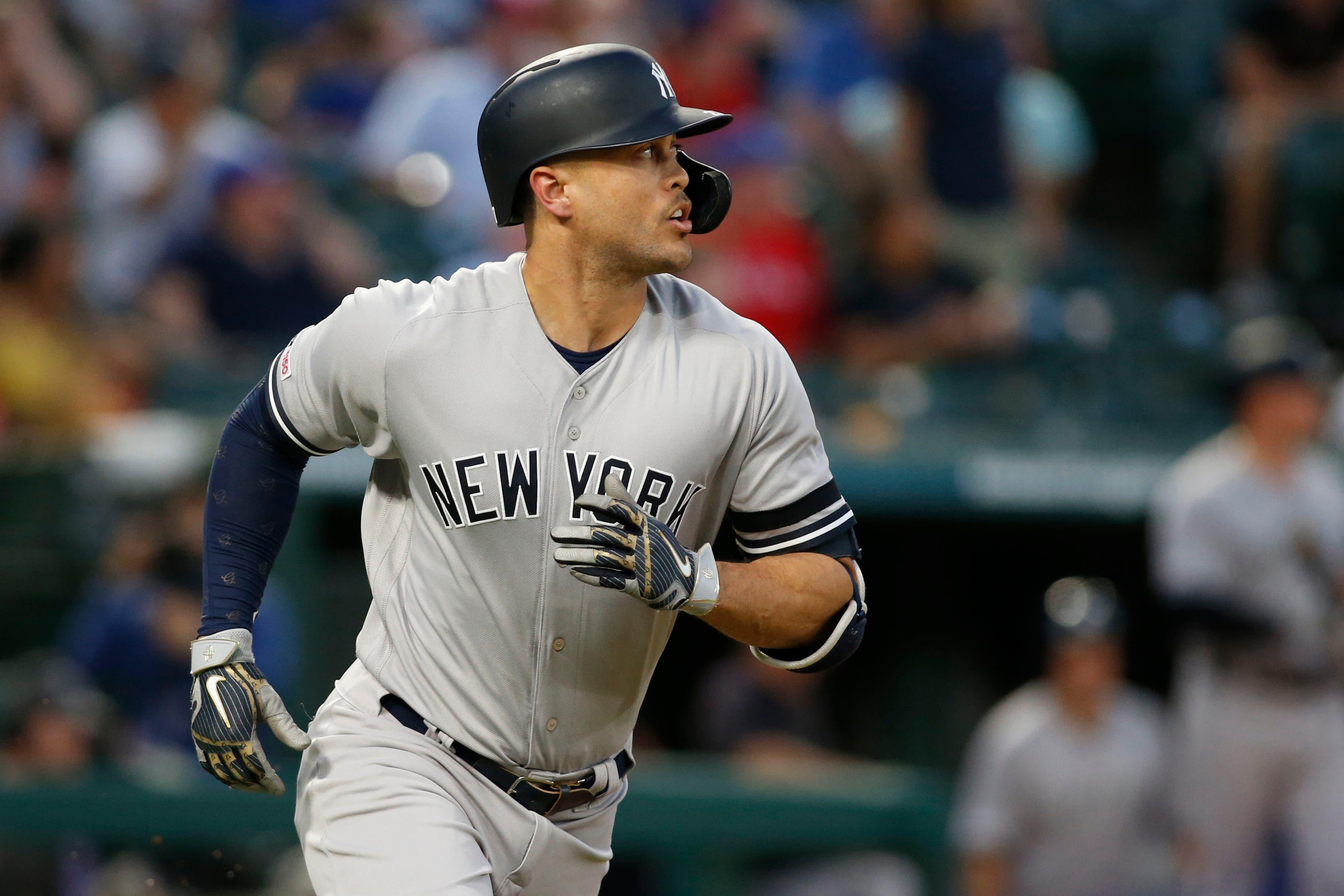 Sep 27, 2019; Arlington, TX, USA; New York Yankees left fielder Giancarlo Stanton (27) watches his home run in the first inning against the Texas Rangers at Globe Life Park in Arlington. Mandatory Credit: Tim Heitman-USA TODAY Sports / Tim Heitman