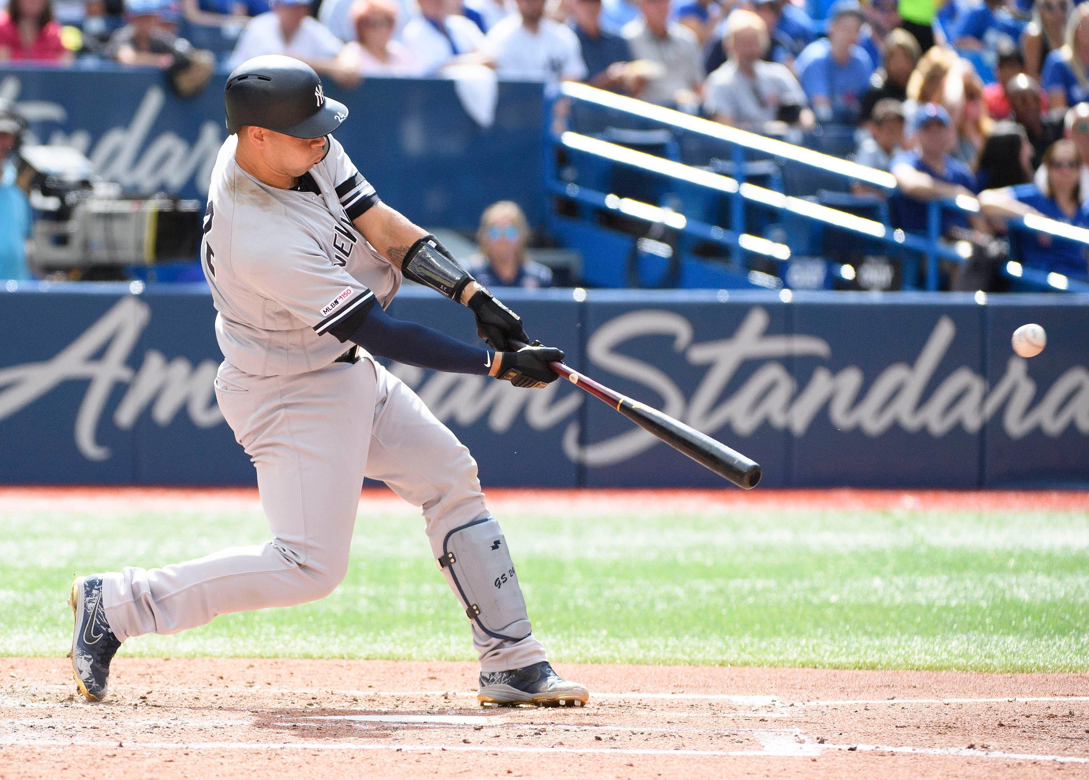 Aug 10, 2019; Toronto, Ontario, CAN; New York Yankees catcher Gary Sanchez (24) hits a home run during the fourth inning against the Toronto Blue Jays at Rogers Centre. Mandatory Credit: Nick Turchiaro-USA TODAY Sports / Nick Turchiaro