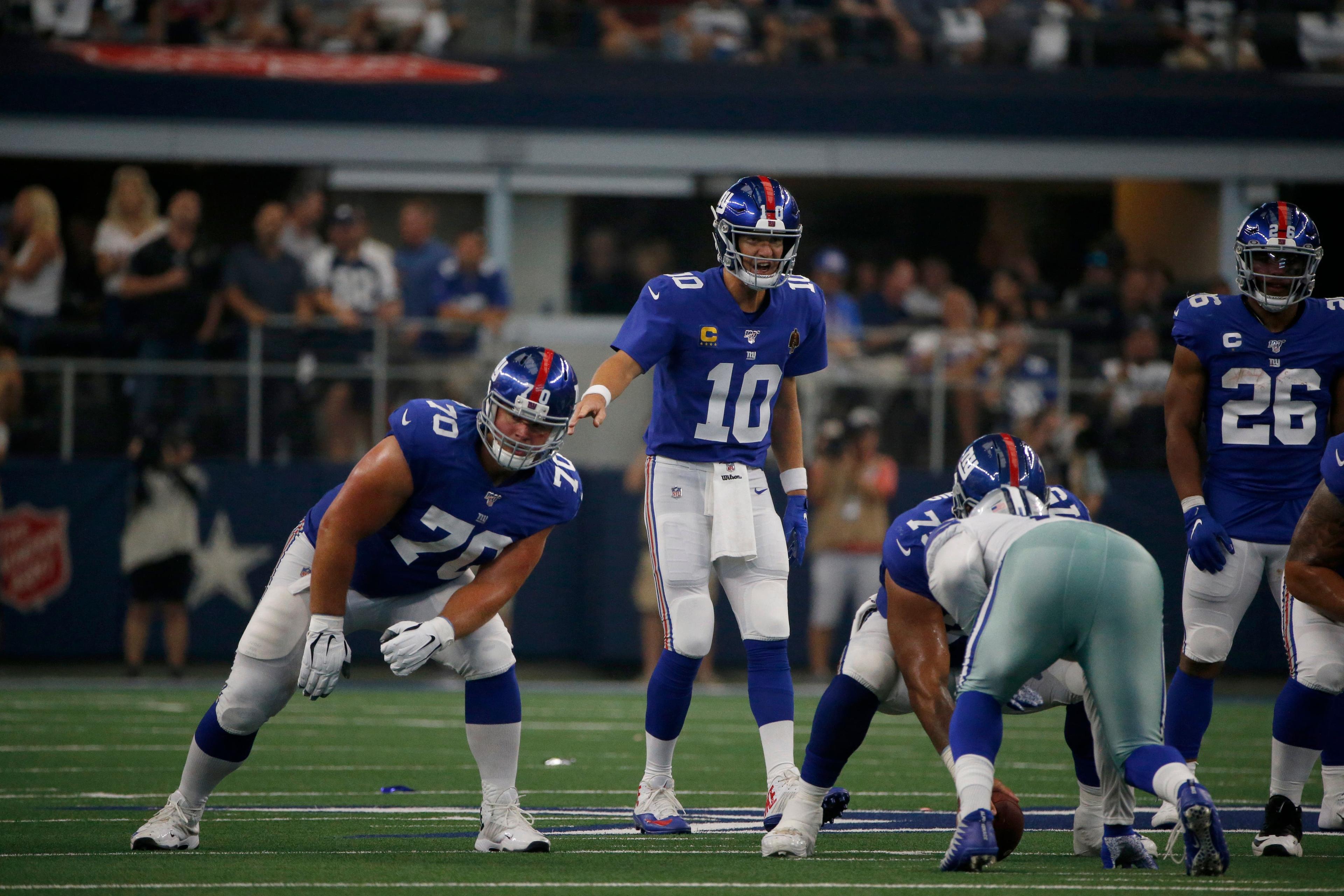 New York Giants' Eli Manning (10) signals the line of scrimmage as Kevin Zeitler (70) and Saquon Barkley (26) look on during a NFL football game against the Dallas Cowboys in Arlington, Texas, Sunday, Sept. 8, 2019. (AP Photo/Michael Ainsworth) / Michael Ainsworth/AP