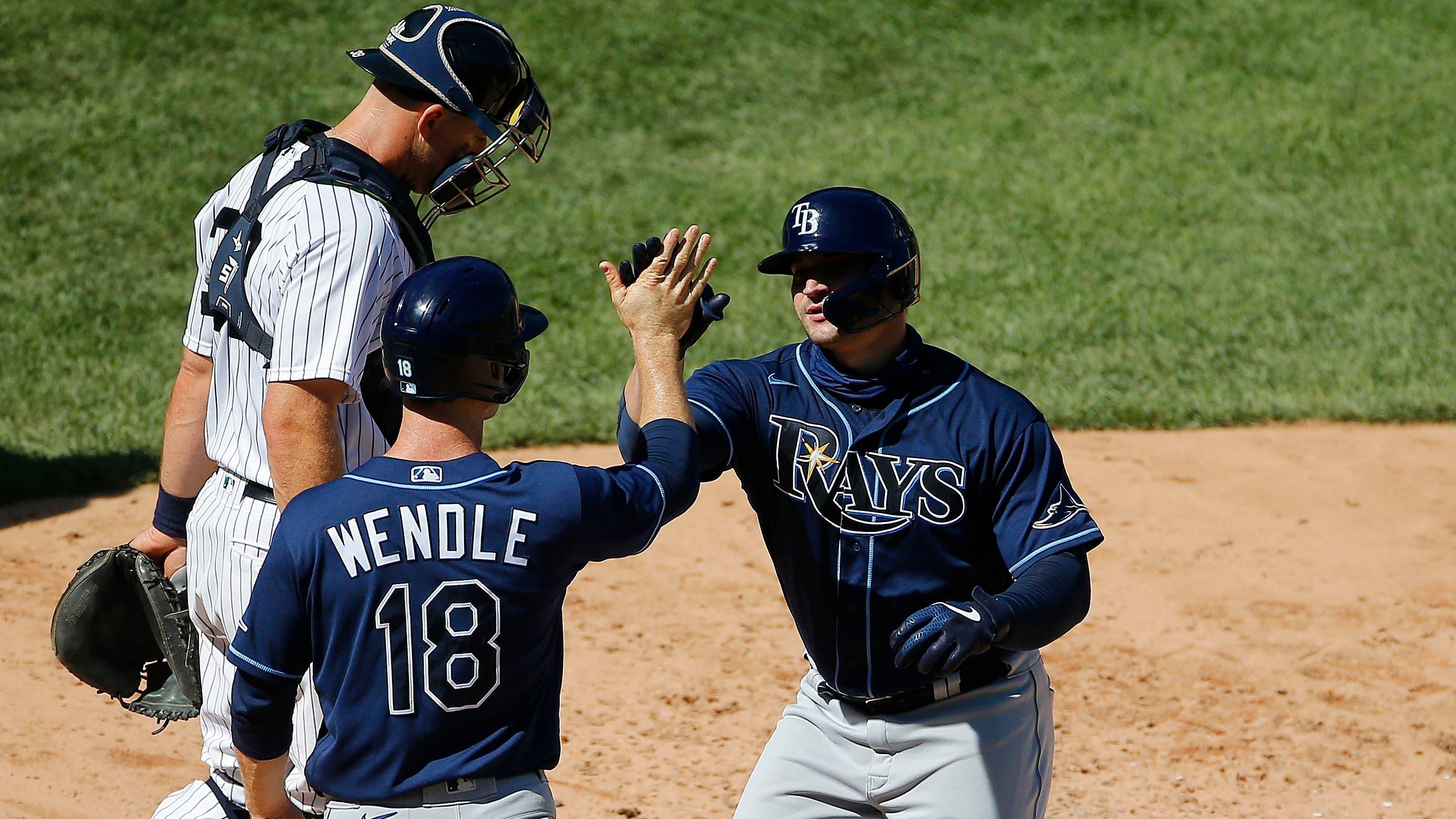 Rays celebrate at home plate at Yankee Stadium / USA TODAY