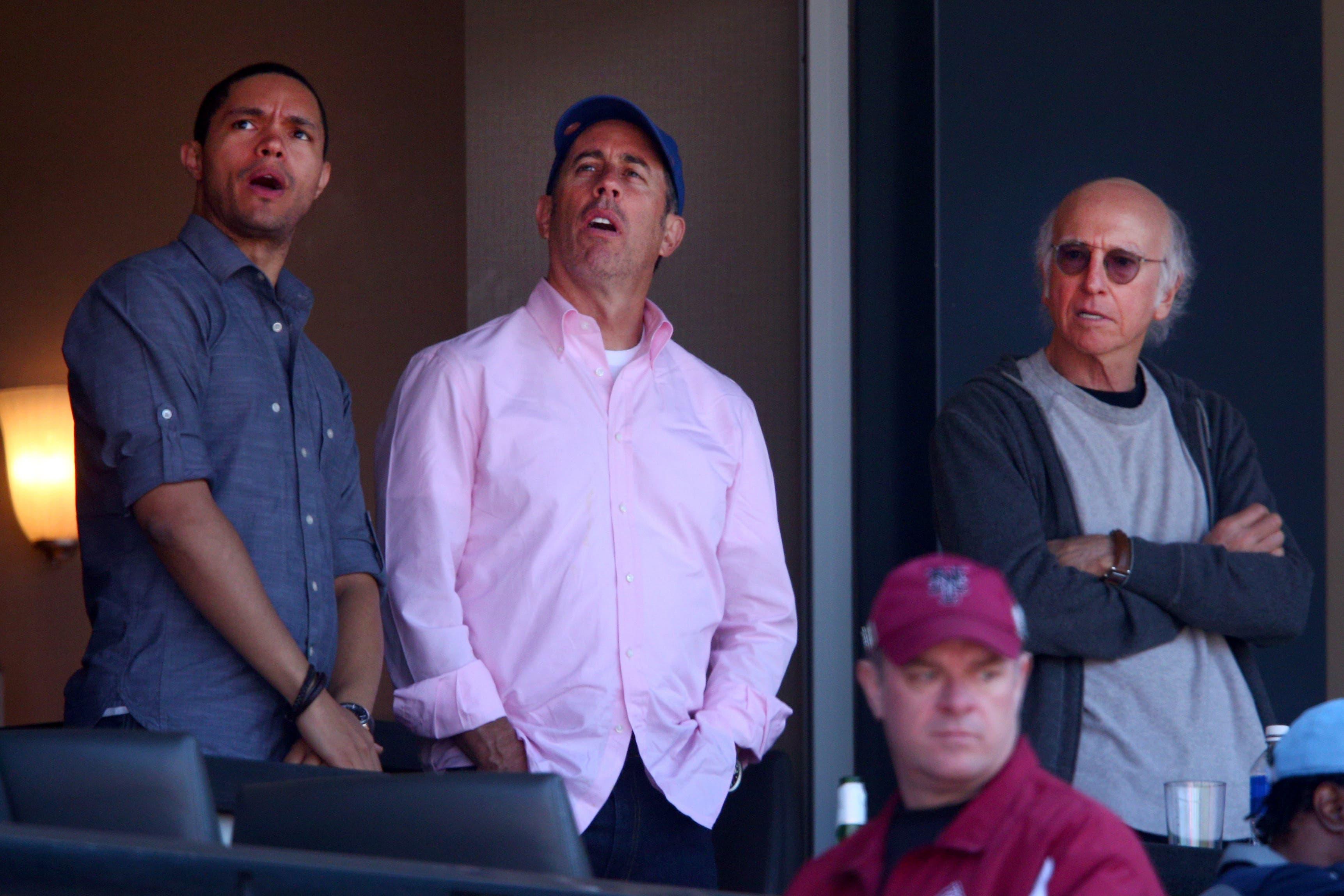 Apr 13, 2015; New York City, NY, USA; Celebrity comedians Trevor Noah (left) and Jerry Seinfeld (center) and Larry David (right) watch an opening day game between the New York Mets and the Philadelphia Phillies at Citi Field. The Mets defeated the Phillies 2-0. Mandatory Credit: Brad Penner-USA TODAY Sports / Brad Penner