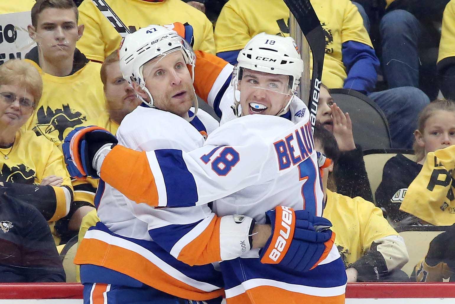 Apr 14, 2019; Pittsburgh, PA, USA; New York Islanders left wing Anthony Beauvillier (18) congratulates right wing Leo Komarov (left) on his goal against the Pittsburgh Penguins during the third period in game three of the first round of the 2019 Stanley Cup Playoffs at PPG PAINTS Arena. New York won 4-1. Mandatory Credit: Charles LeClaire-USA TODAY Sports / Charles LeClaire