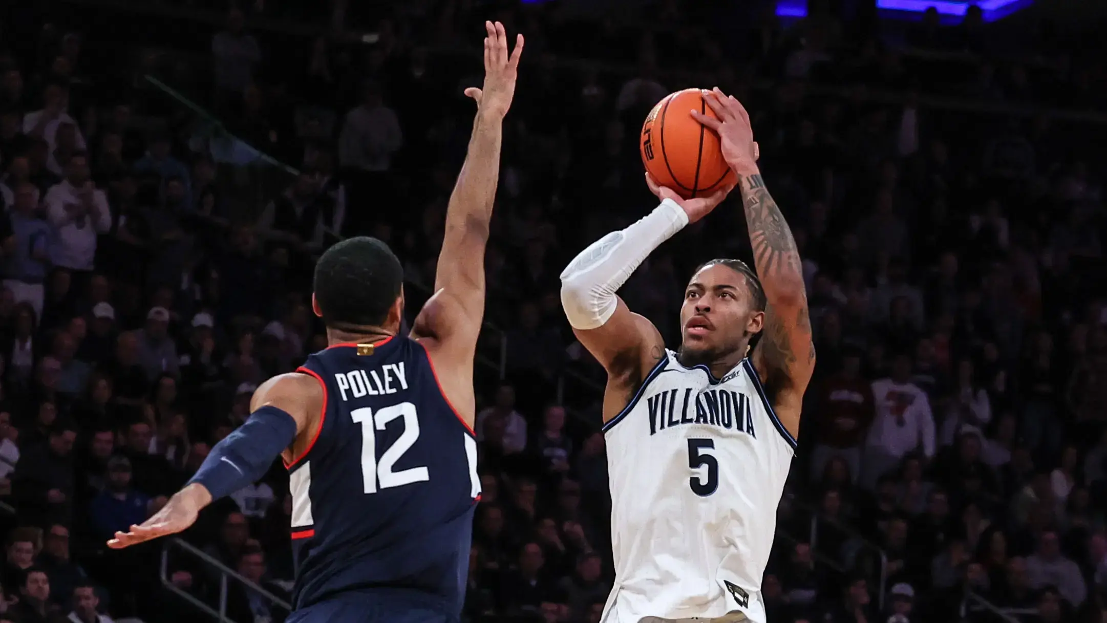 Mar 11, 2022; New York, NY, USA; Villanova Wildcats guard Justin Moore (5) shoots the ball as Connecticut Huskies forward Tyler Polley (12) defends during the first half at Madison Square Garden. / Vincent Carchietta-USA TODAY Sports