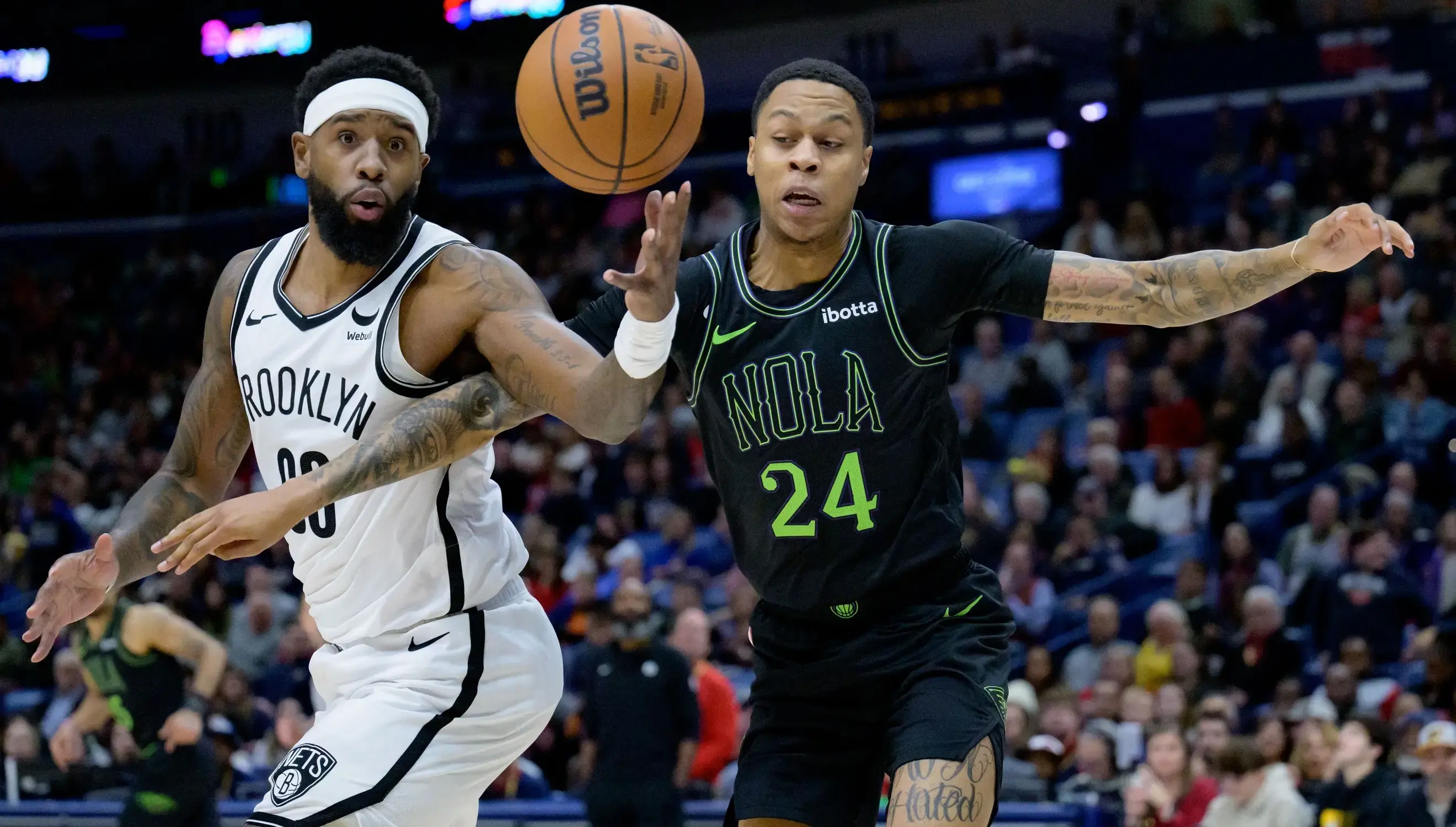 New Orleans Pelicans guard Jordan Hawkins (24) and Brooklyn Nets forward Royce O'Neale (00) battle for the ball during the first half at Smoothie King Center. / Matthew Hinton-USA TODAY Sports