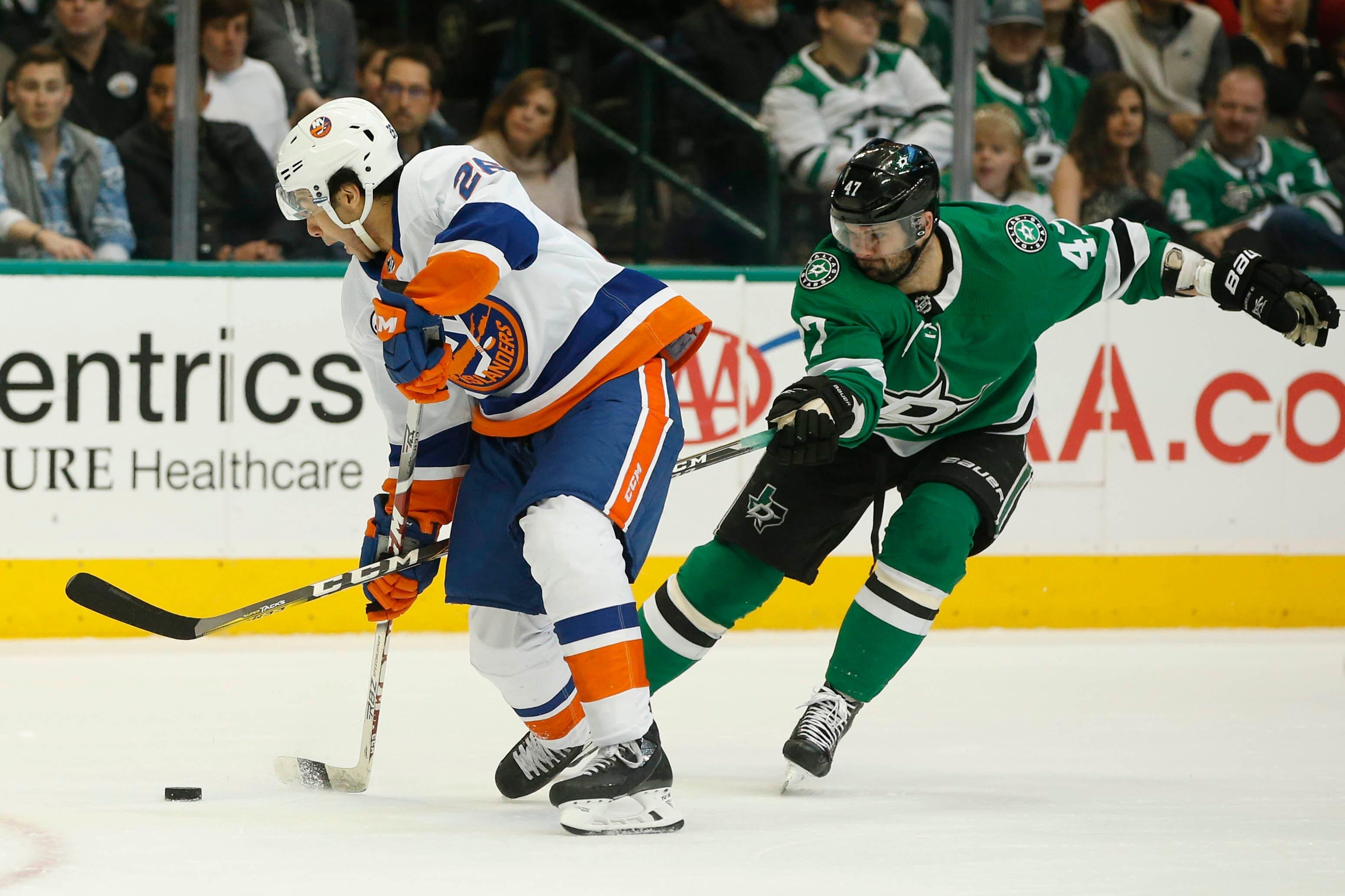 Dallas Stars right wing Alexander Radulov is called for hooking against New York Islanders right wing Joshua Ho-Sang in the first period at American Airlines Center. / Tim Heitman/USA TODAY Sports