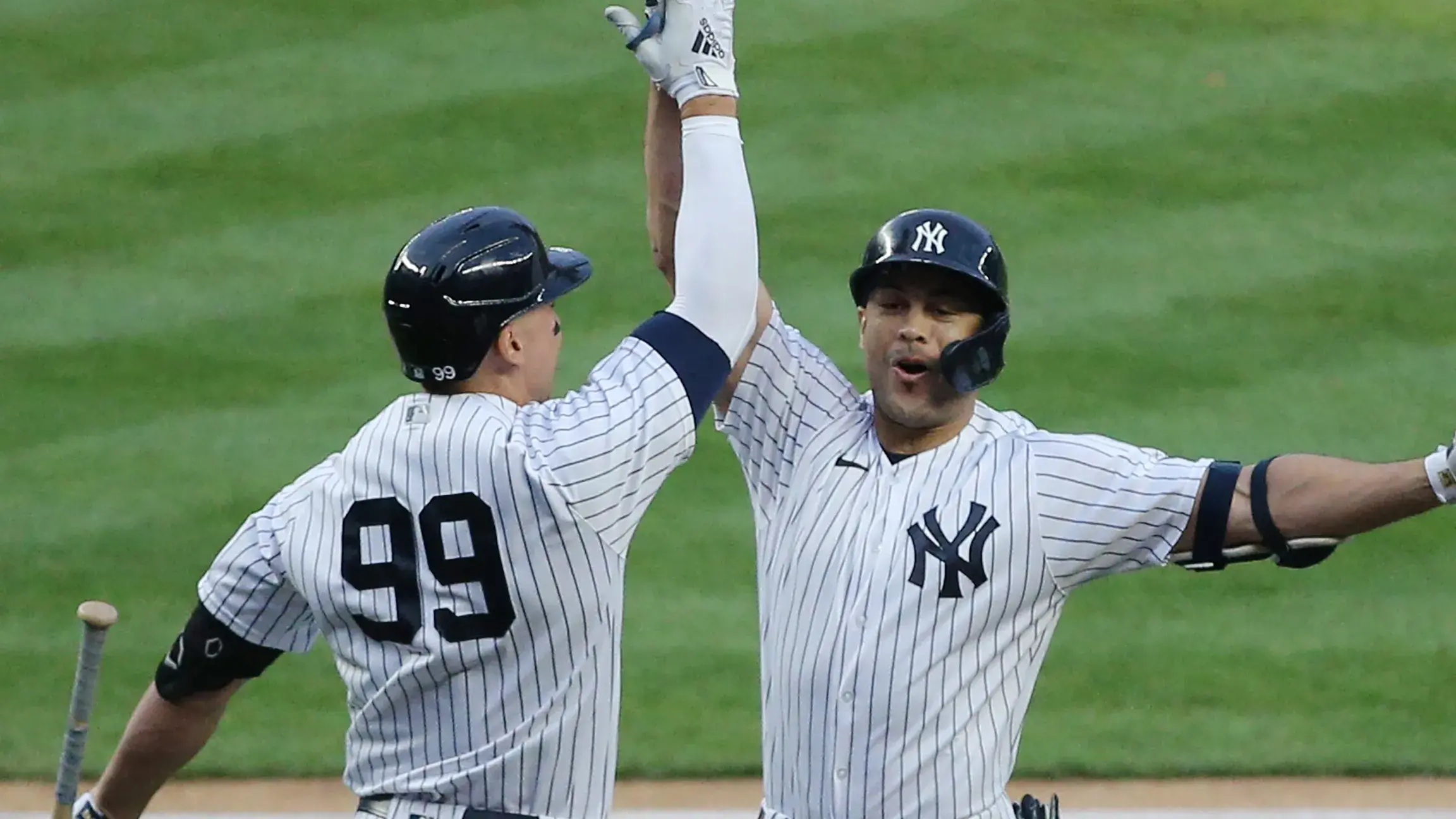 May 4, 2021; Bronx, New York, USA; New York Yankees designated hitter Giancarlo Stanton (27) celebrates with right fielder Aaron Judge (99) after hitting a two-run home run against the Houston Astros during the first inning at Yankee Stadium. / © Brad Penner-USA TODAY Sports