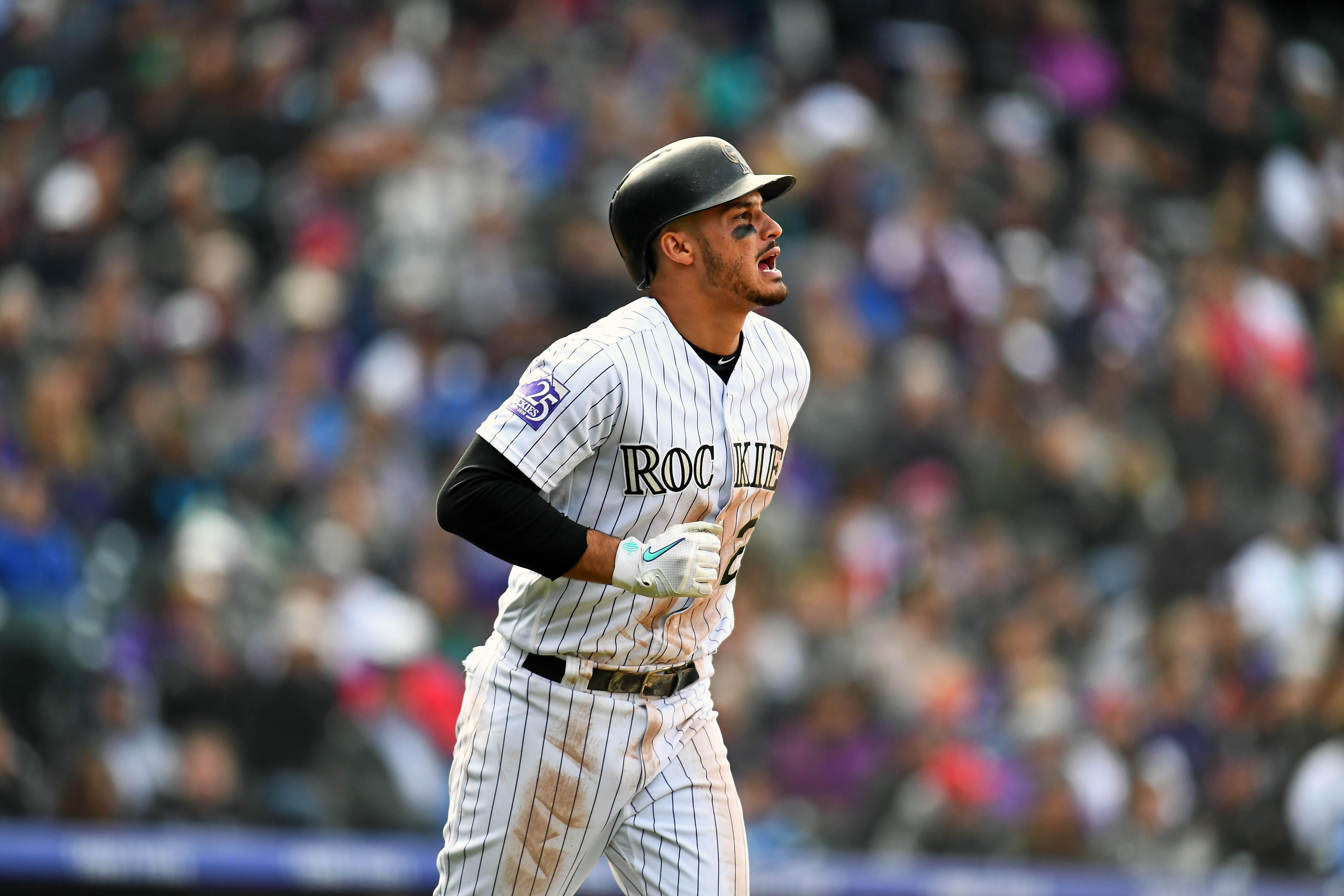 Sep 30, 2018; Denver, CO, USA; Colorado Rockies third baseman Nolan Arenado (28) takes a bases on balls walk in the eighth inning against the Washington Nationals at Coors Field. Mandatory Credit: Ron Chenoy-USA TODAY Sports