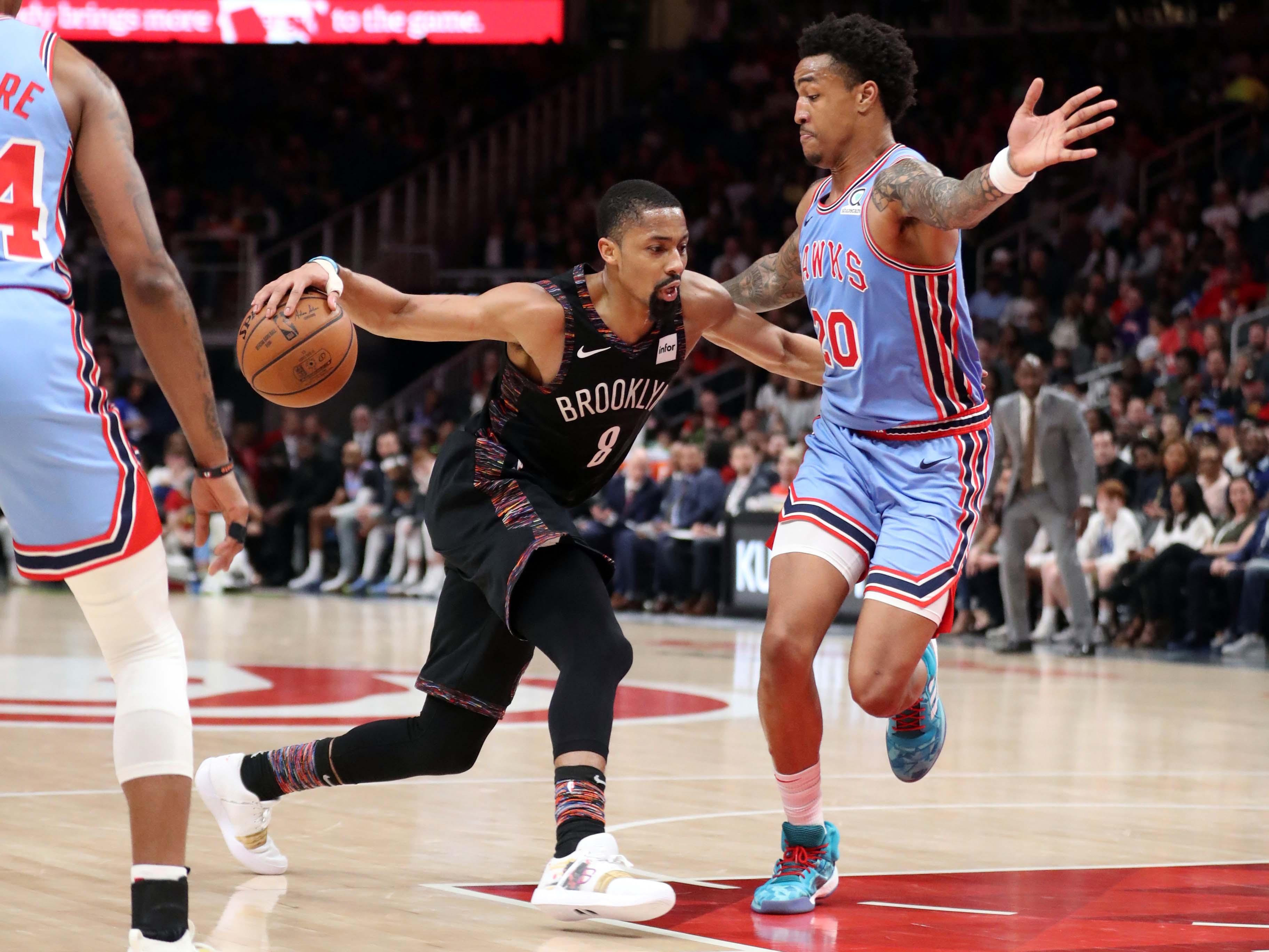 Brooklyn Nets guard Spencer Dinwiddie drives against Atlanta Hawks forward John Collins in the second half at State Farm Arena.