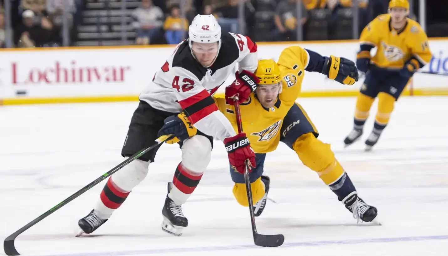 Nashville Predators left wing Mark Jankowski (17) and New Jersey Devils center Curtis Lazar (42) fight for the puck during the second period at Bridgestone Arena. / Steve Roberts-USA TODAY Sports