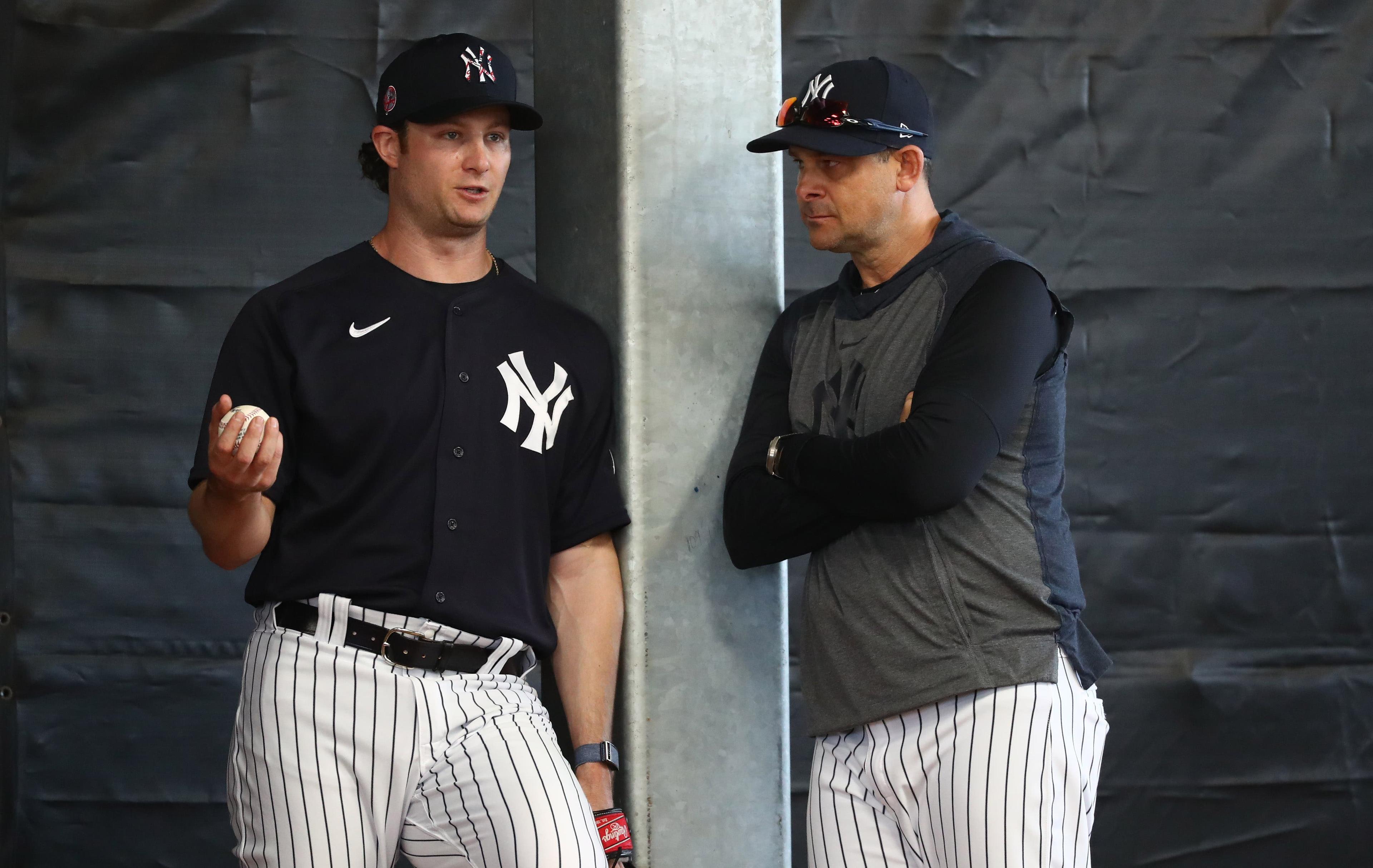 Feb 16, 2020; Tampa, Florida, USA; New York Yankees starting pitcher Gerrit Cole (45) and manager Aaron Boone (17) talk works out during spring training at George M. Steinbrenner Field. Mandatory Credit: Kim Klement-USA TODAY Sports / Kim Klement