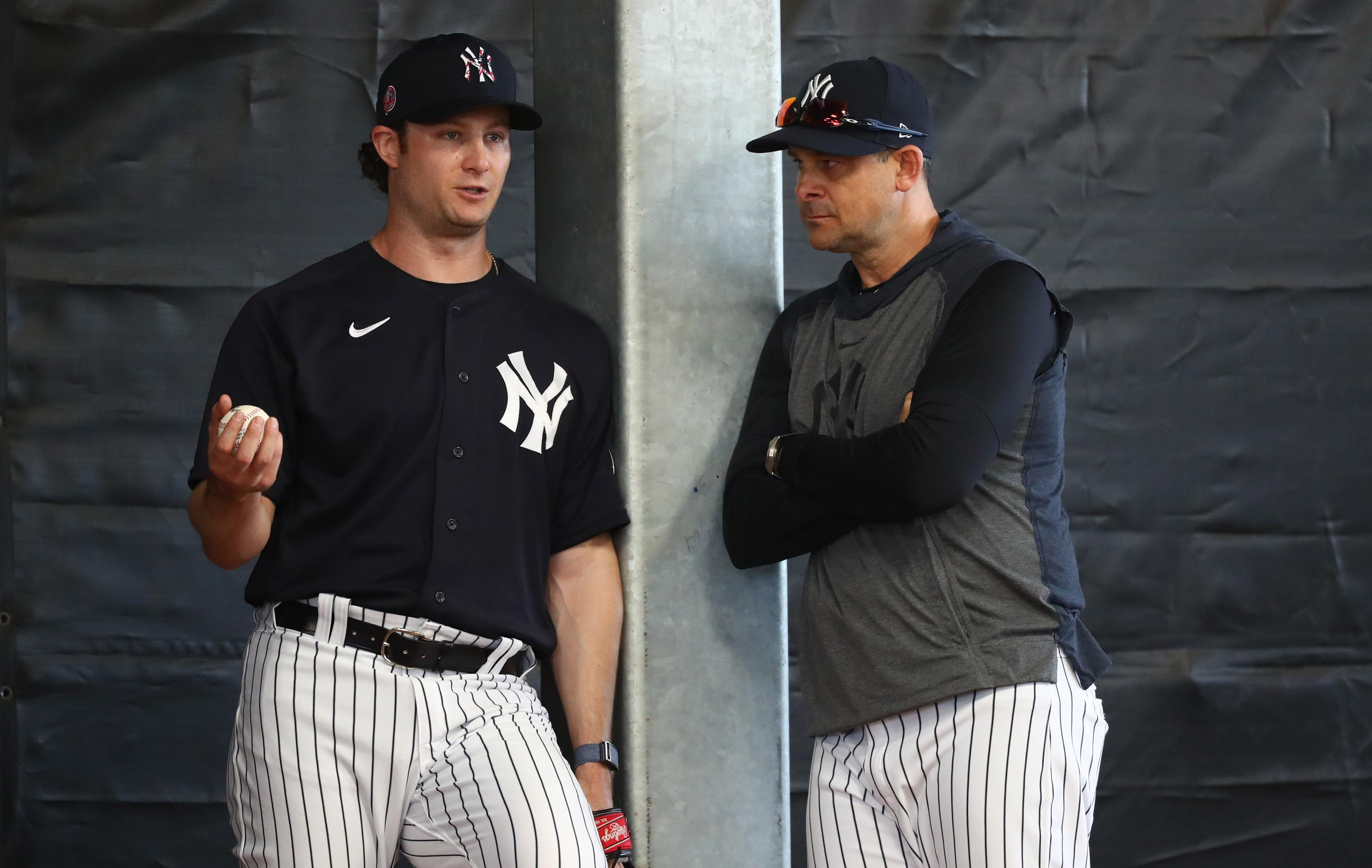 Feb 16, 2020; Tampa, Florida, USA; New York Yankees starting pitcher Gerrit Cole (45) and manager Aaron Boone (17) talk works out during spring training at George M. Steinbrenner Field. Mandatory Credit: Kim Klement-USA TODAY Sports