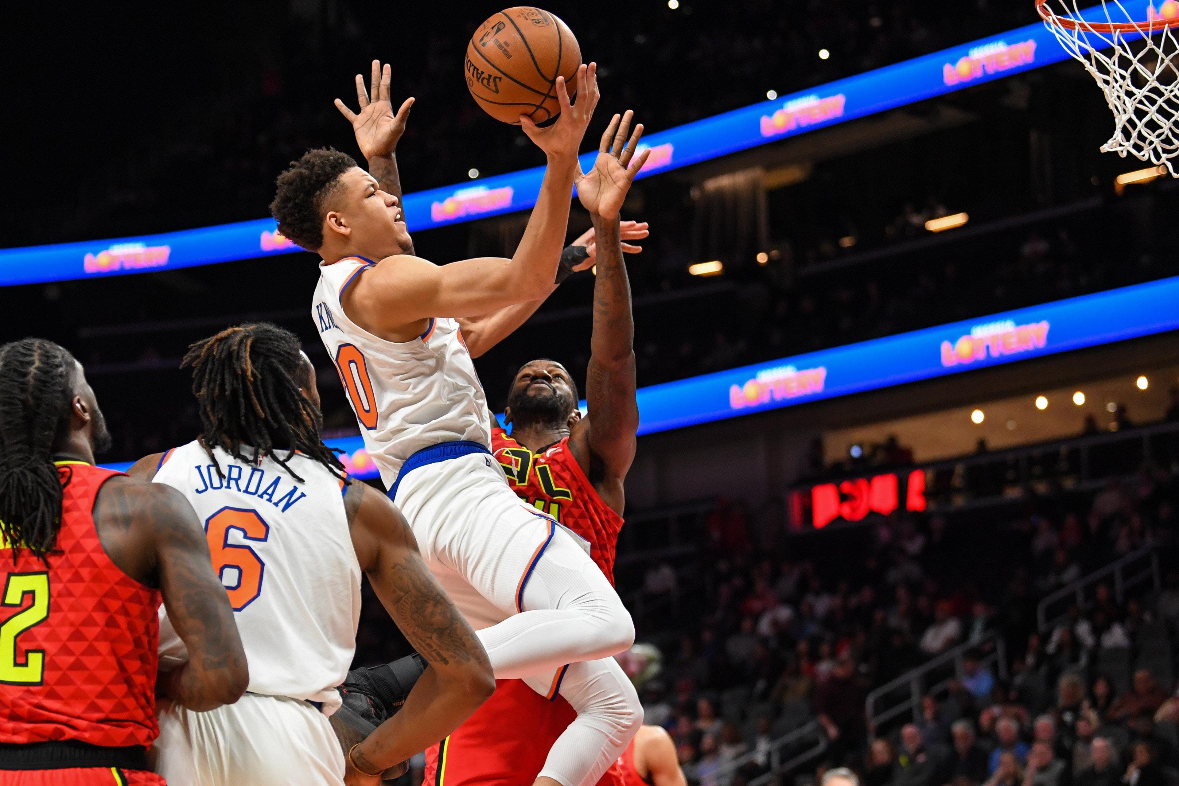 Feb 14, 2019; Atlanta, GA, USA; New York Knicks forward Kevin Knox (20) drives to the basket against Atlanta Hawks center Dewayne Dedmon (14) during the first half at State Farm Arena. Mandatory Credit: Dale Zanine-USA TODAY Sports / Dale Zanine