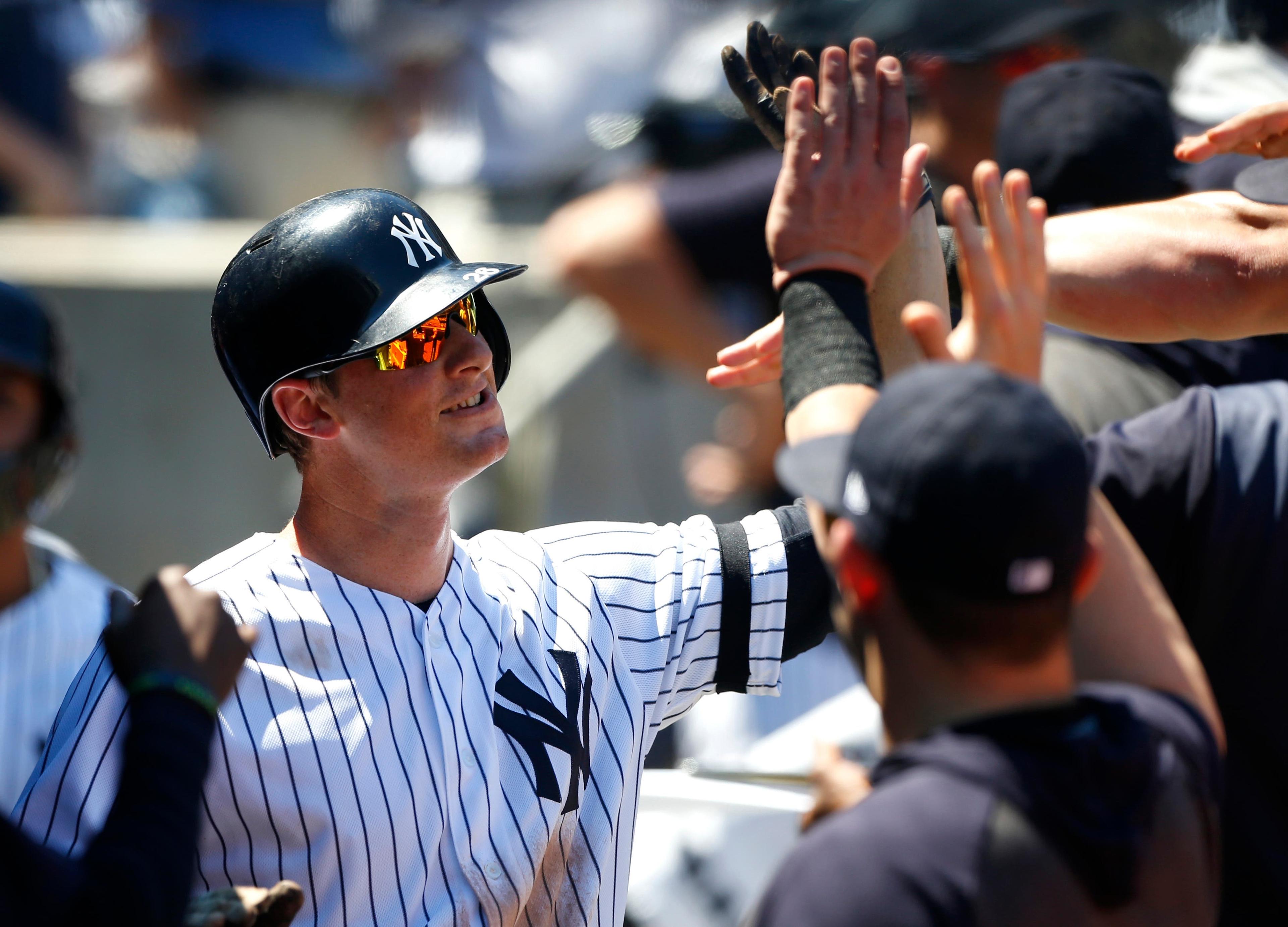 Jun 26, 2019; Bronx, NY, USA; New York Yankees third baseman DJ LeMahieu (26) celebrates in the dugout after hitting a home run against the Toronto Blue Jays in the fourth inning at Yankee Stadium. Mandatory Credit: Noah K. Murray-USA TODAY Sports / Noah K. Murray