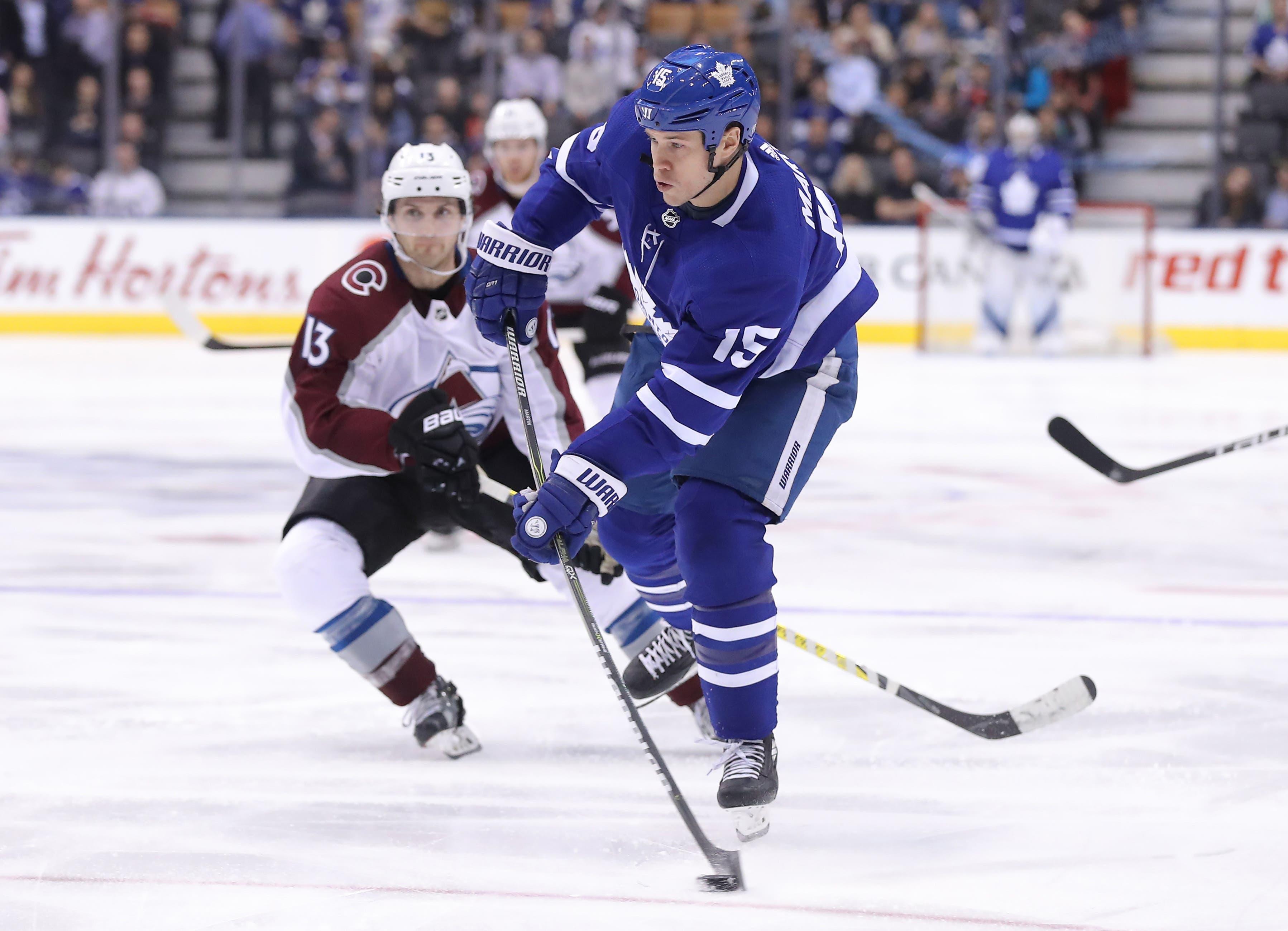 Jan 22, 2018; Toronto, Ontario, CAN; Toronto Maple Leafs left wing Matt Martin (15) shoots the puck against the Colorado Avalanche at Air Canada Centre. The Avalanche beat the Maple Leafs 4-2. Mandatory Credit: Tom Szczerbowski-USA TODAY Sports / Tom Szczerbowski